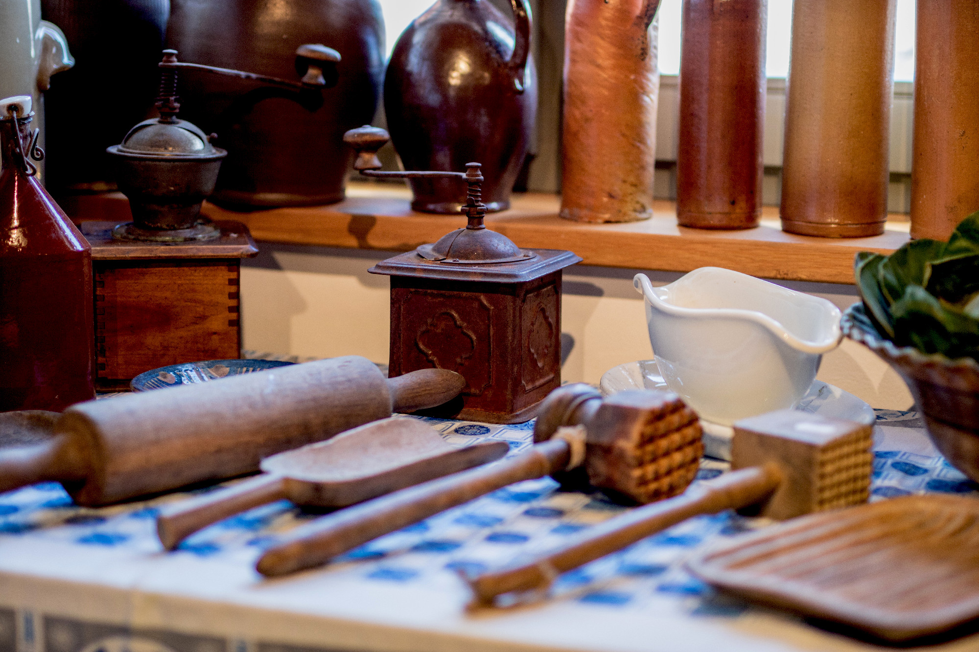 Old cooking tools on a wooden kitchen table. Accessories for coo