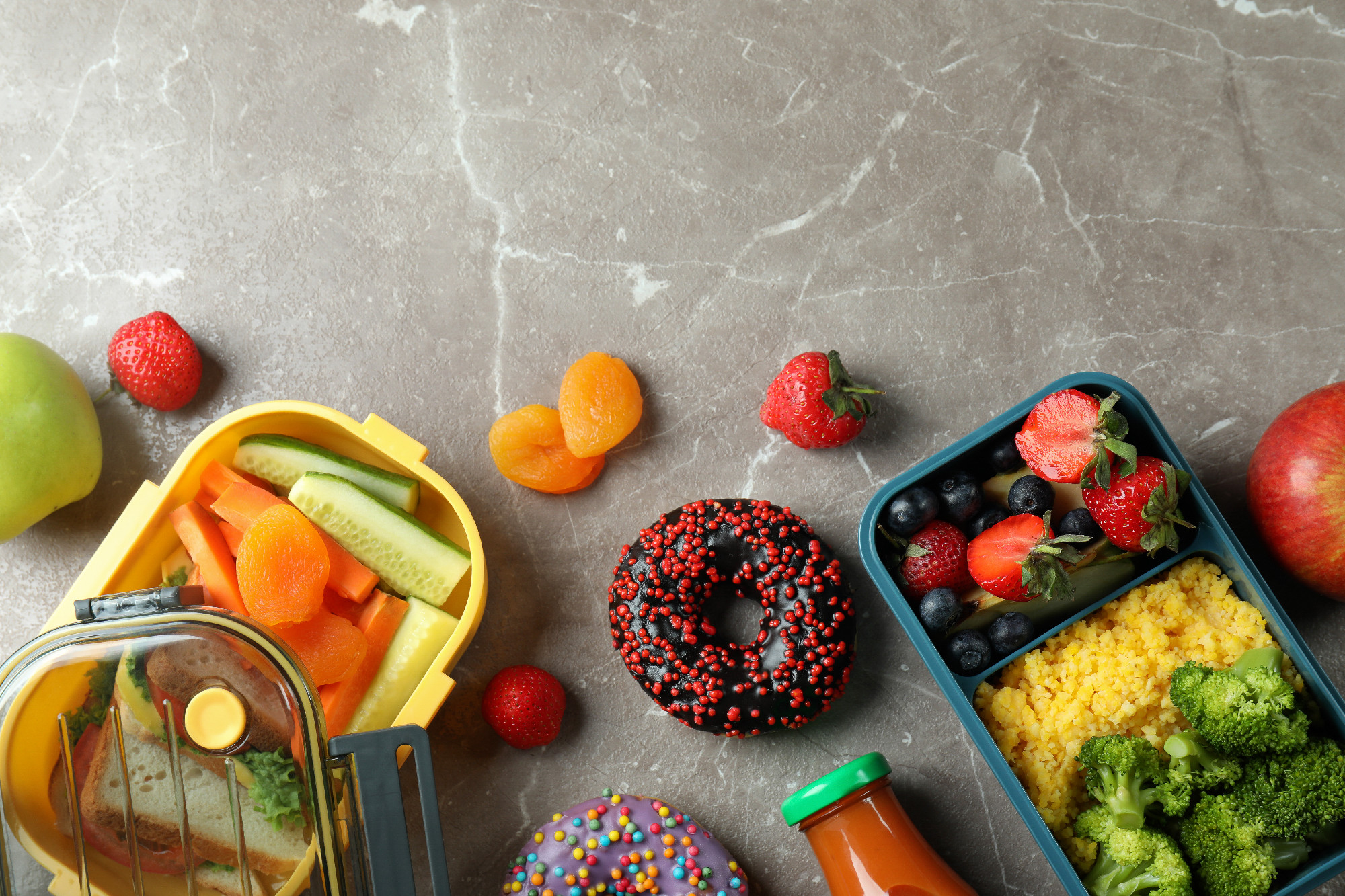 Lunch boxes with tasty food on gray textured table