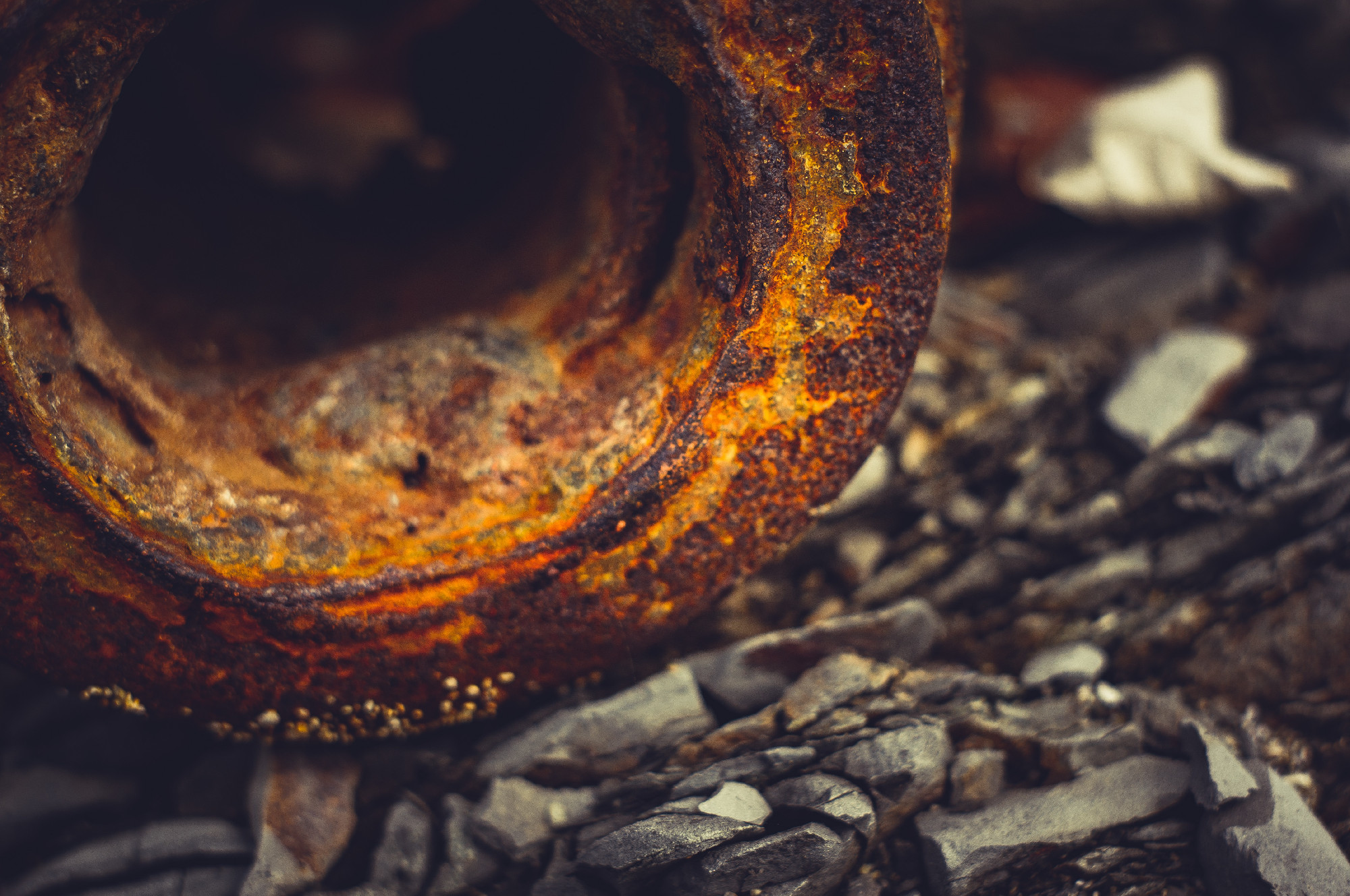Very rusty metal on a gray cracked rock