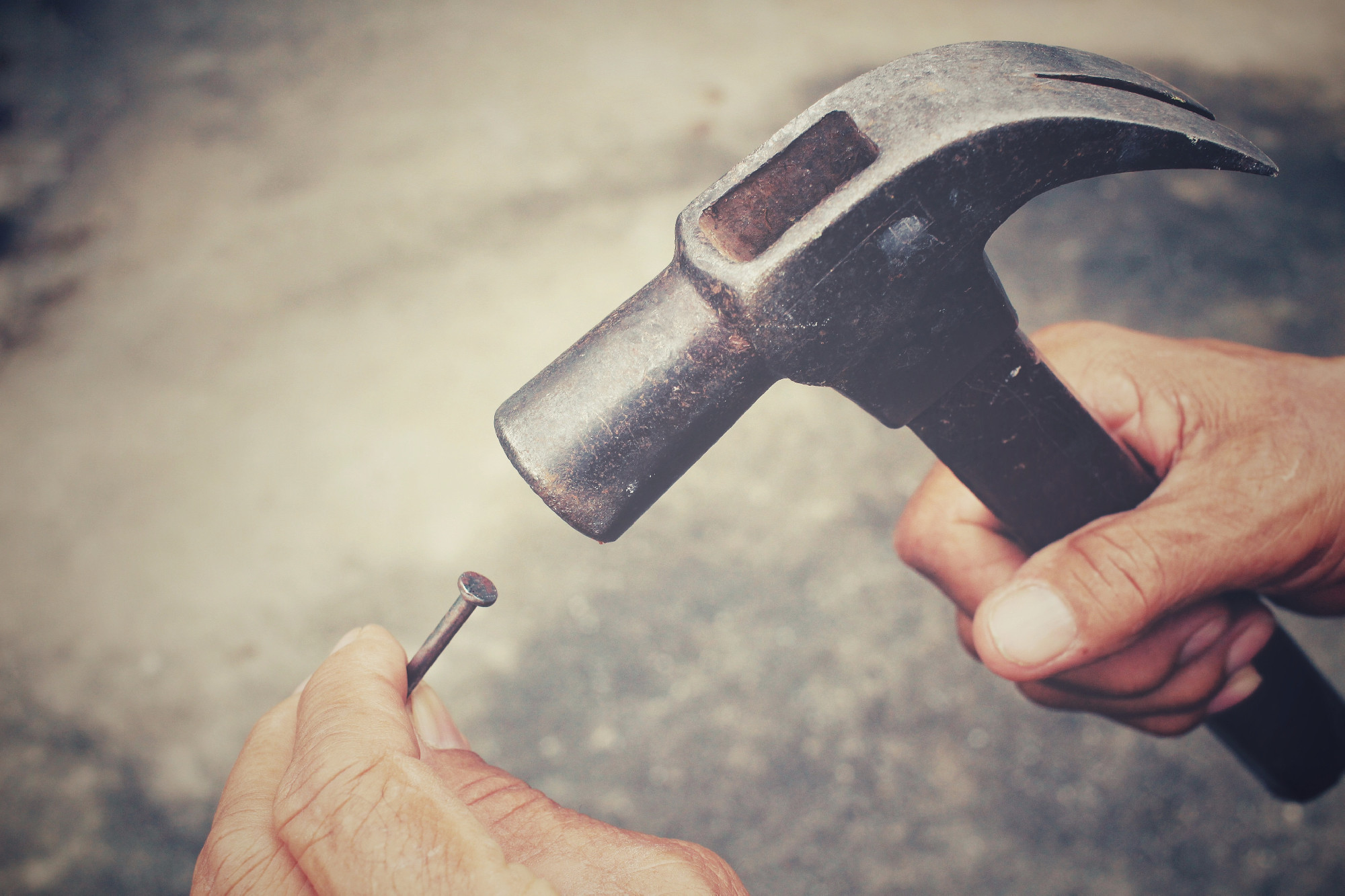 Man with hammer and nails on hand