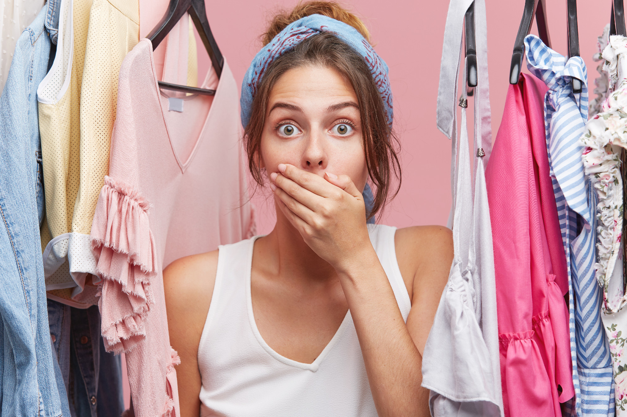 Portrait of shocked female model covering mouth with hand, looking with bugged eyes into camera, forgetting to irone her costume, lating for business meeting. People, shock, great surprisment