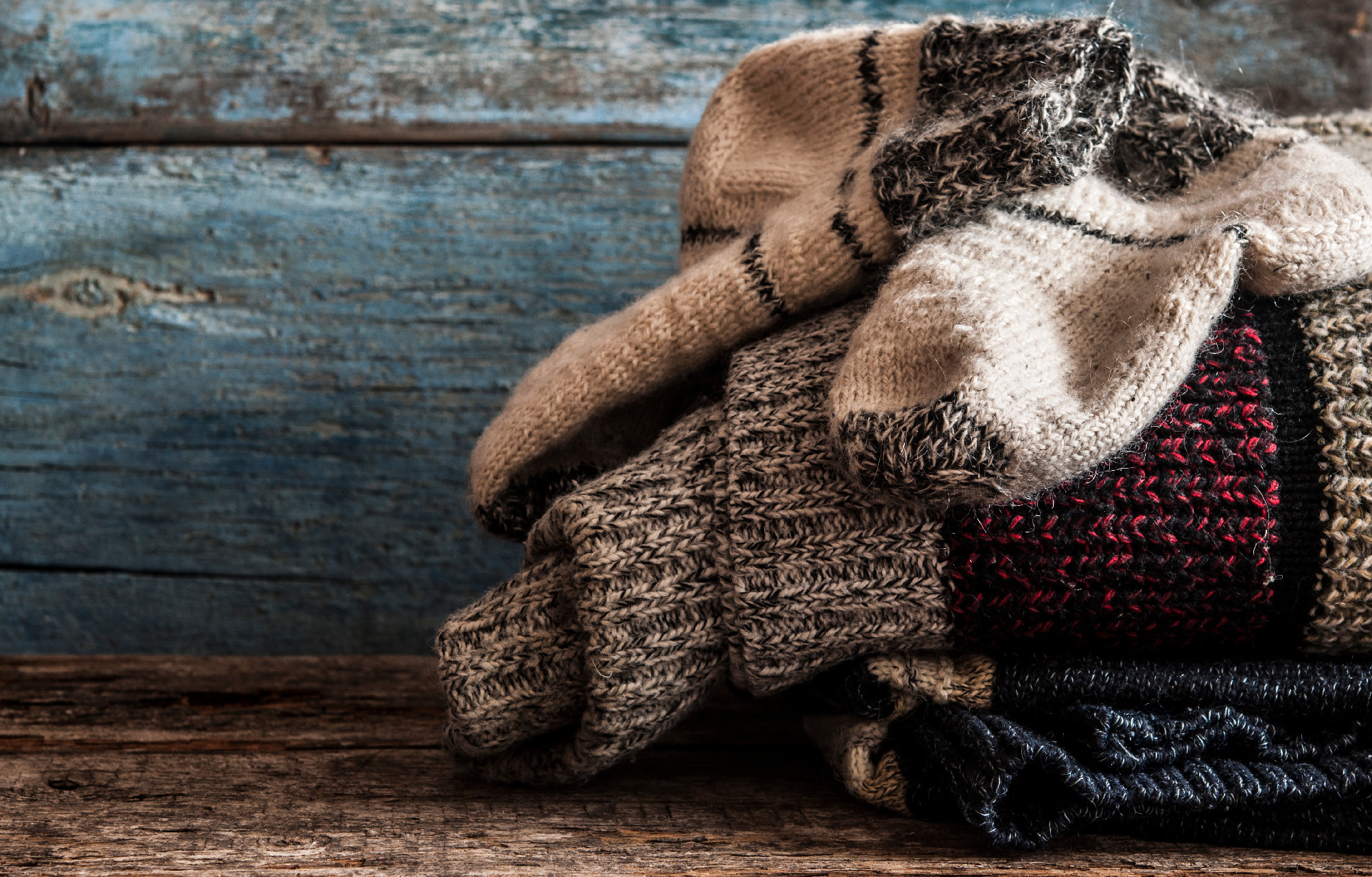 Pair of wool socks against wood background