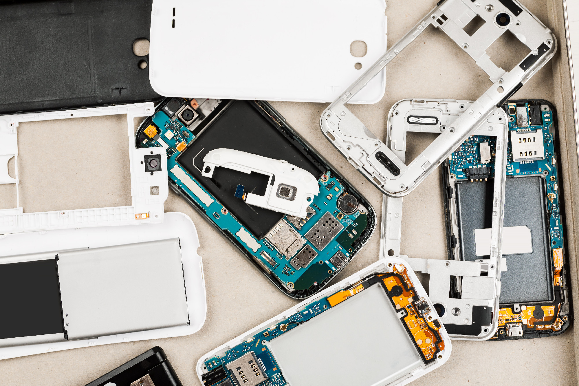 Disassembled cell phones and other gadgets in repair shop