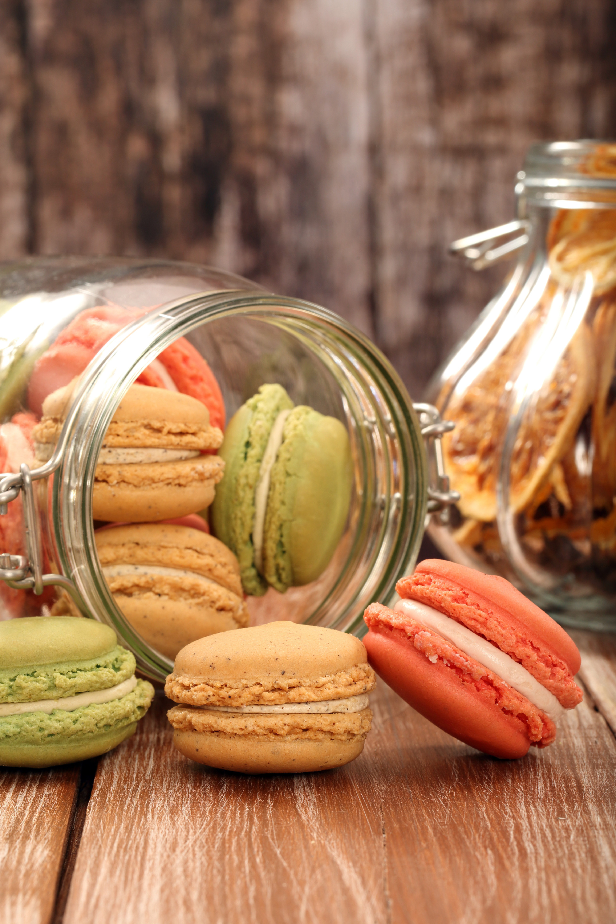 Homemade meringue macaroons in the jar on wooden background