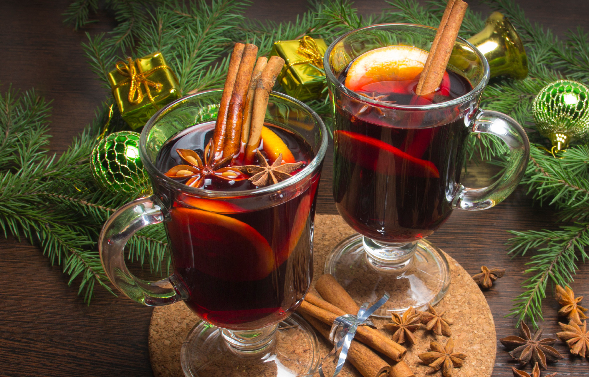 Glass of delicious mulled wine on table, closeup