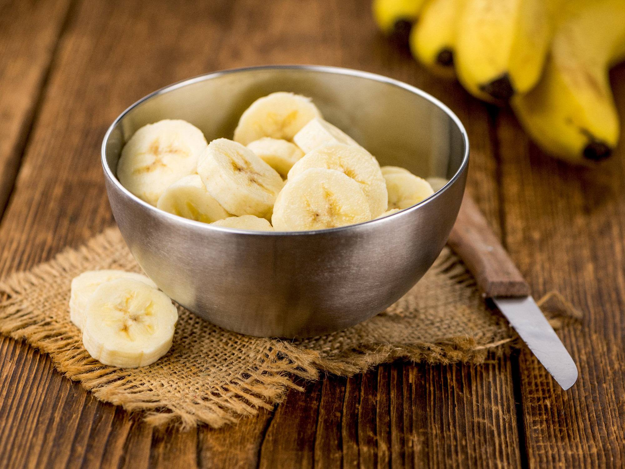 Portion of Sliced Bananas on wooden background, selective focus