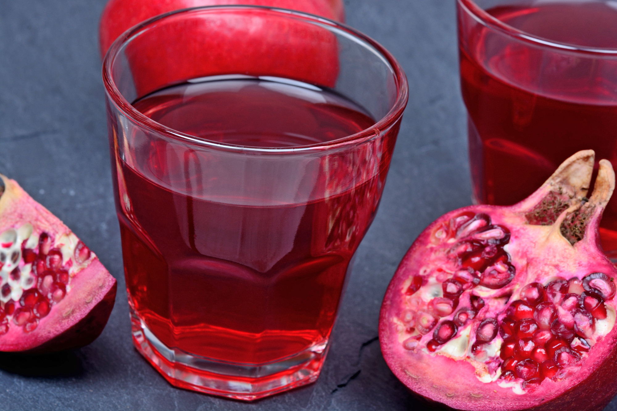 Pomegranate juice in a glasses on slate