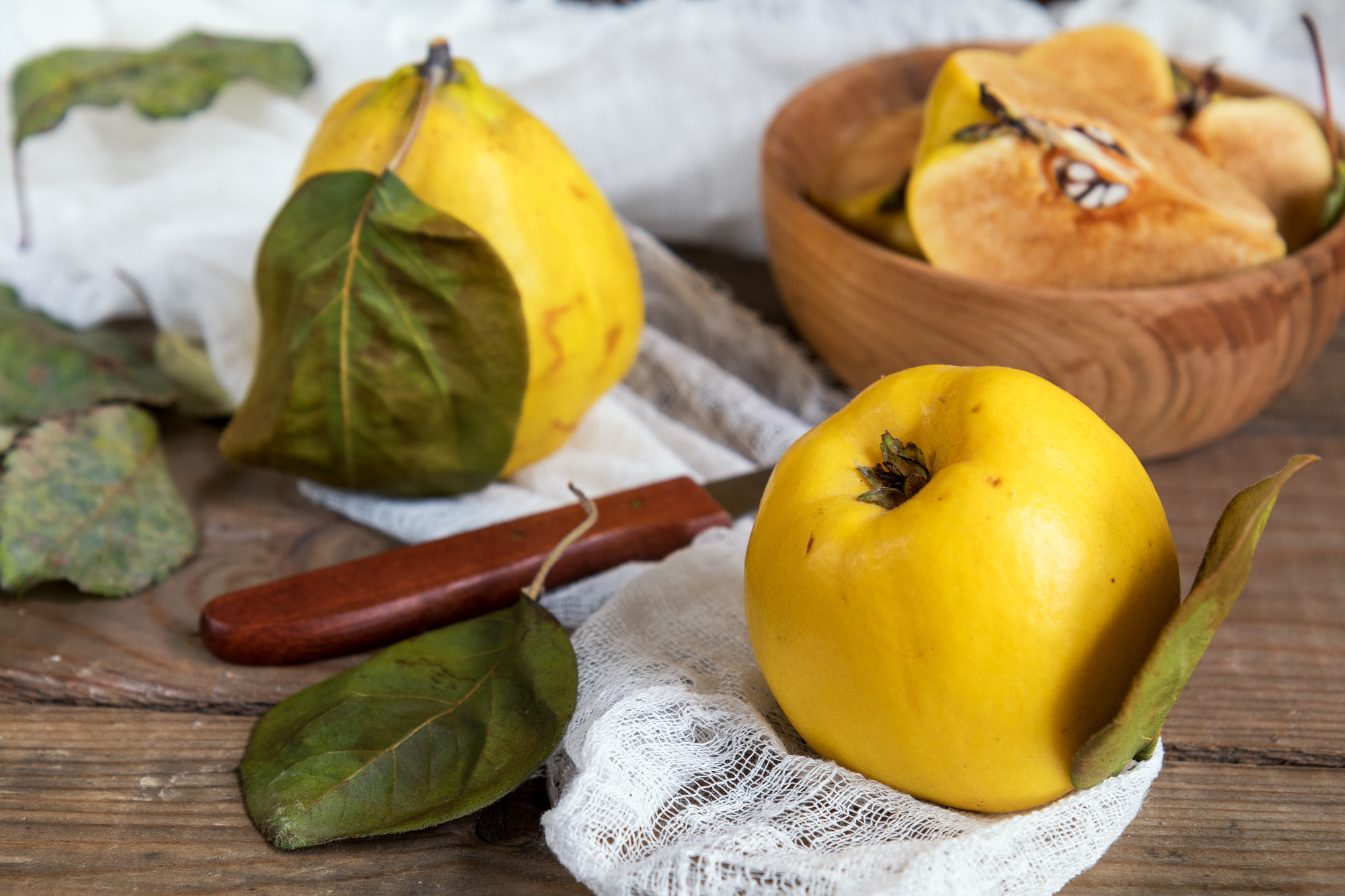 Fresh quince fruit on dark wooden table