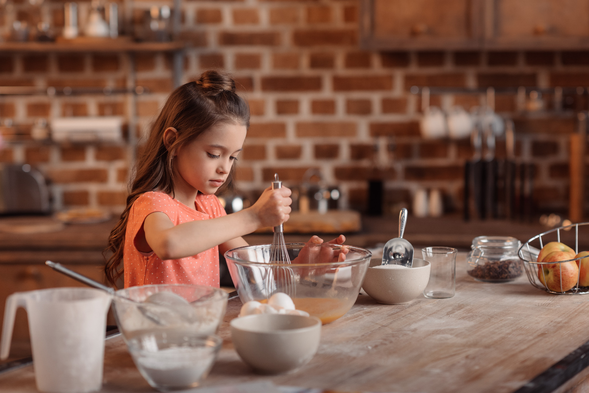 girl mixing ingredients for dough for cake