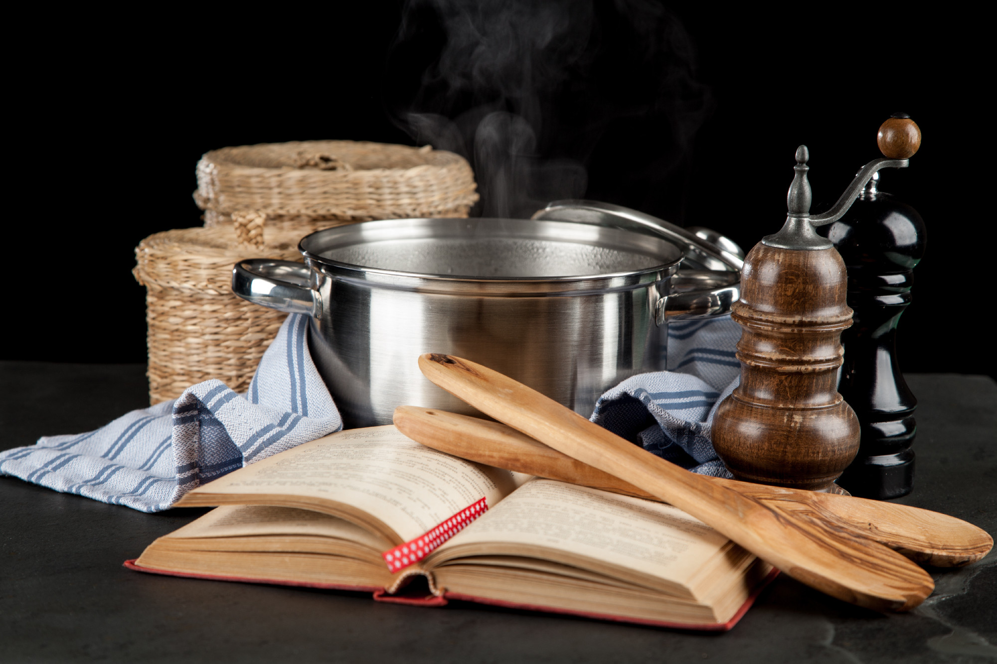 Steaming pot on black background