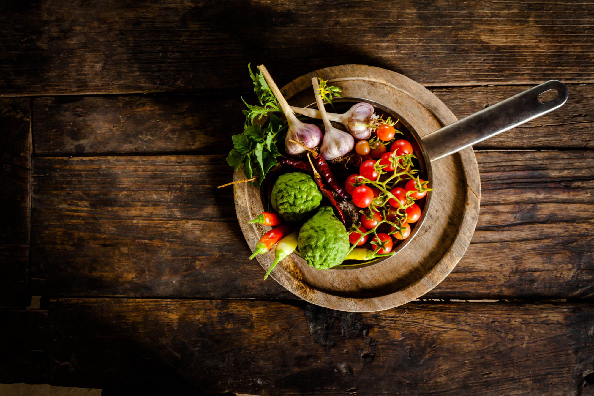 Condiments and spices for creative cooking on dark rustic wooden