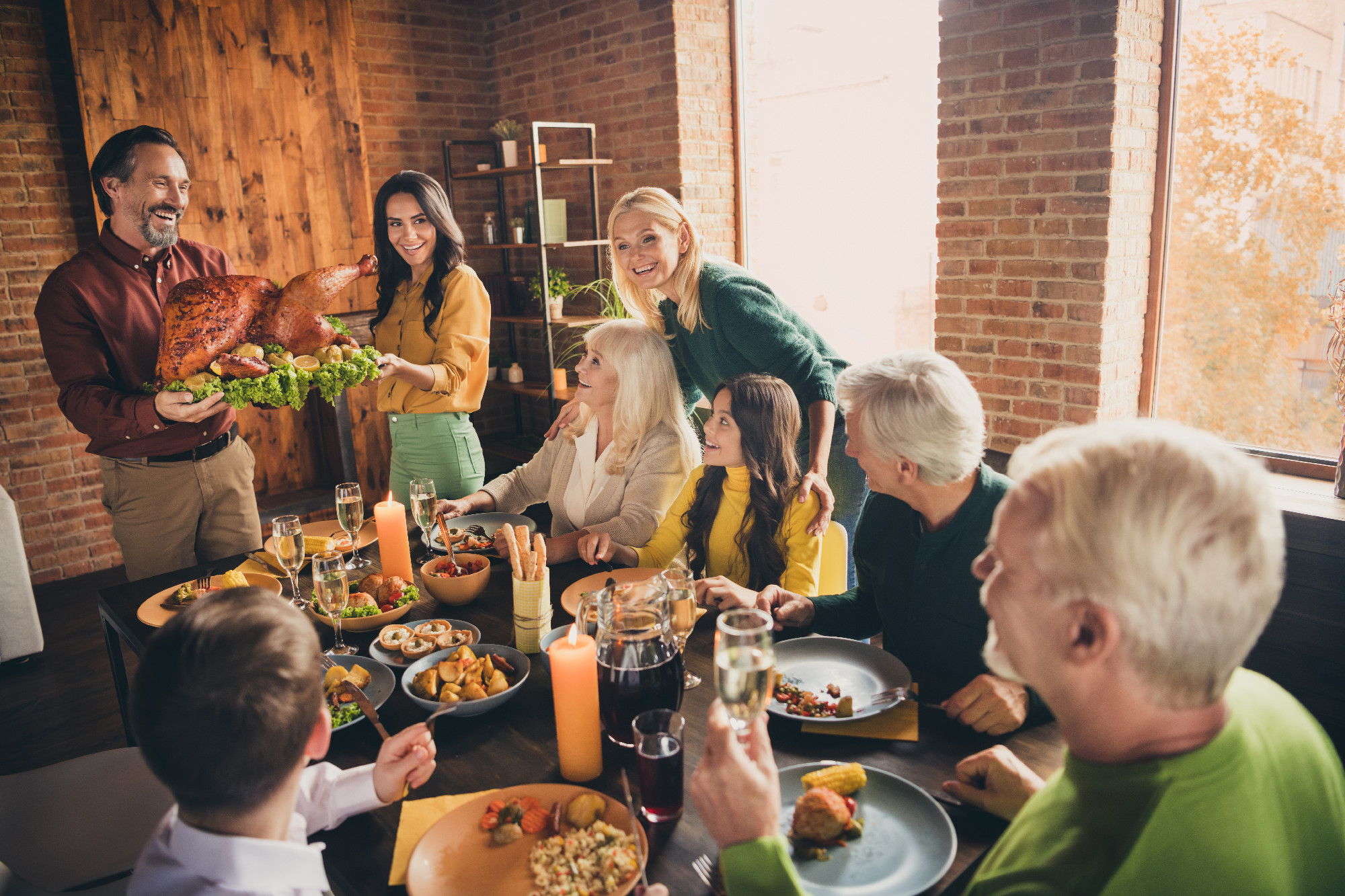 Portrait of nice attractive cheerful affectionate family gathering housekeeper carrying plate fresh homemade turkey serving table spending time at modern loft industrial brick interior house