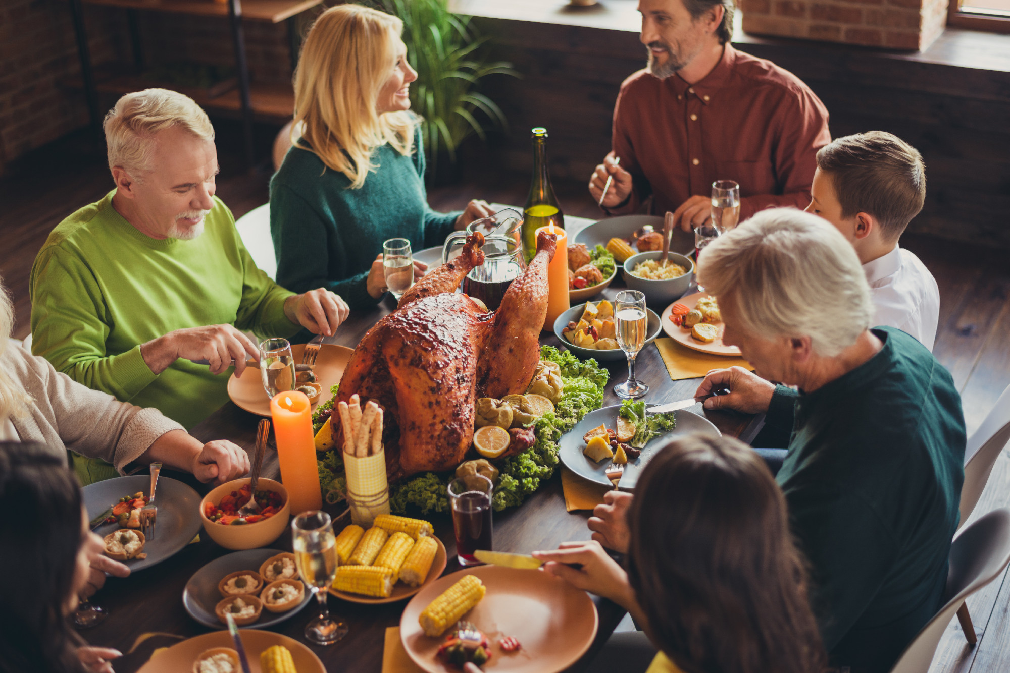 Holiday feast table family relatives gathering thanks giving dinner communication living room indoors