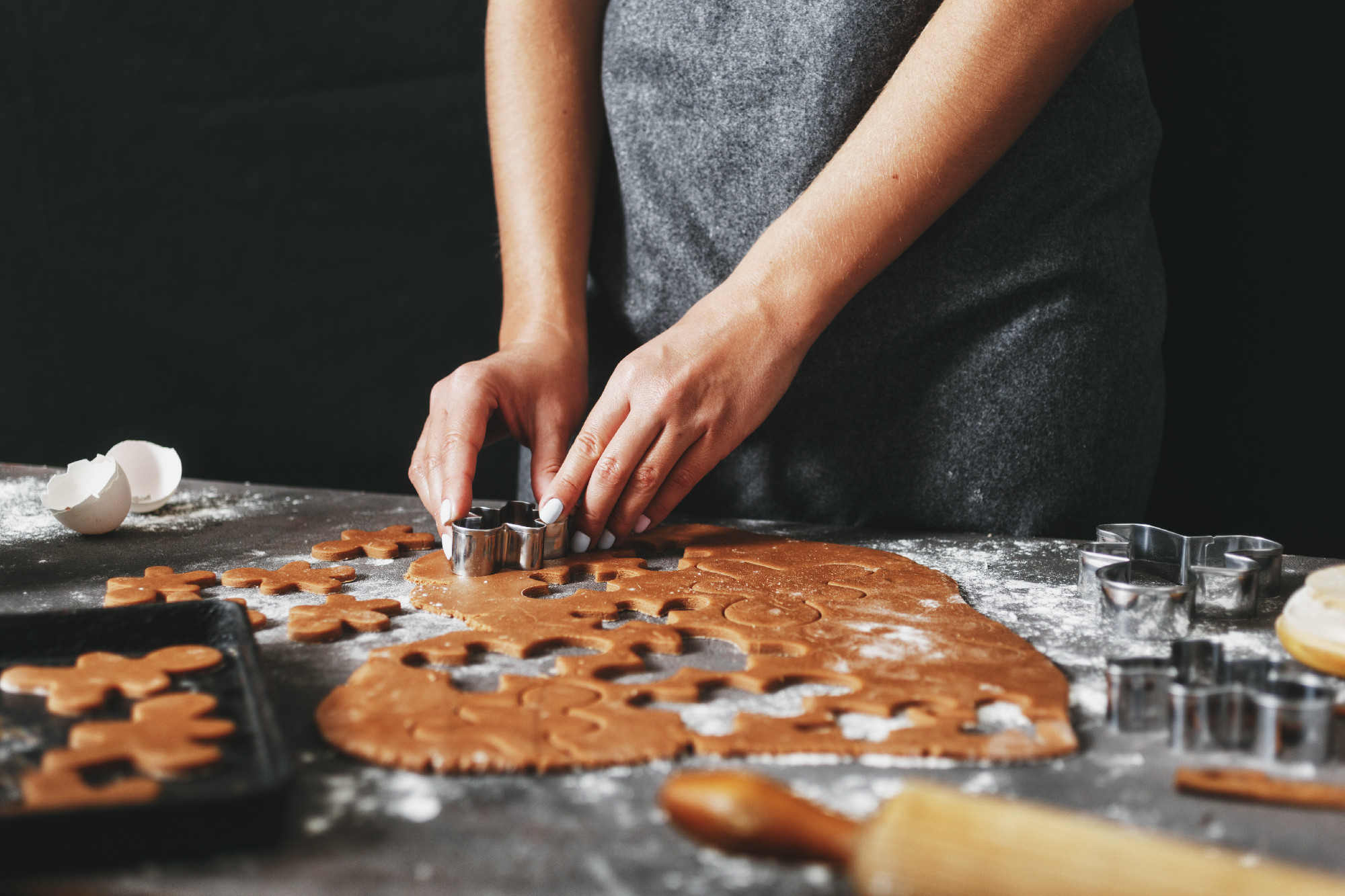 Woman preparing Christmas holiday cookies ginger men