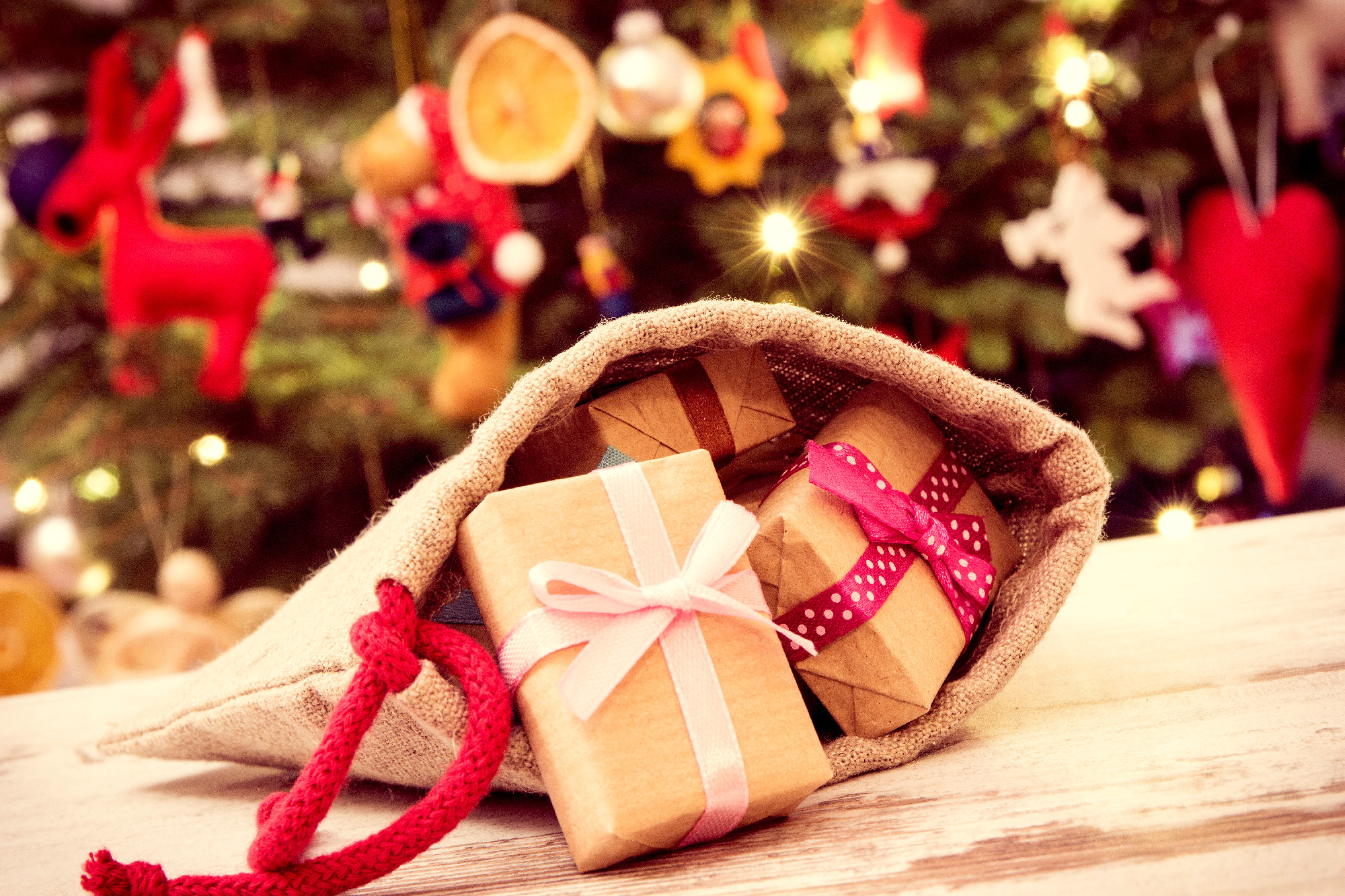 Vintage photo, Wrapped gifts with ribbons in jute bag for Christ