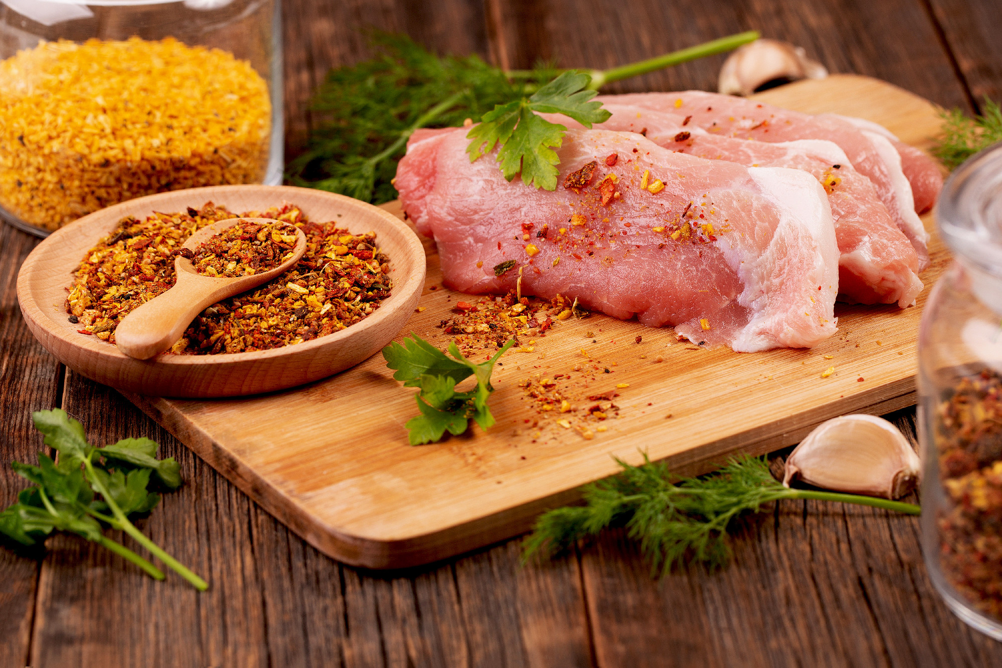 Pork pieces and spices close up. Cooking pork.