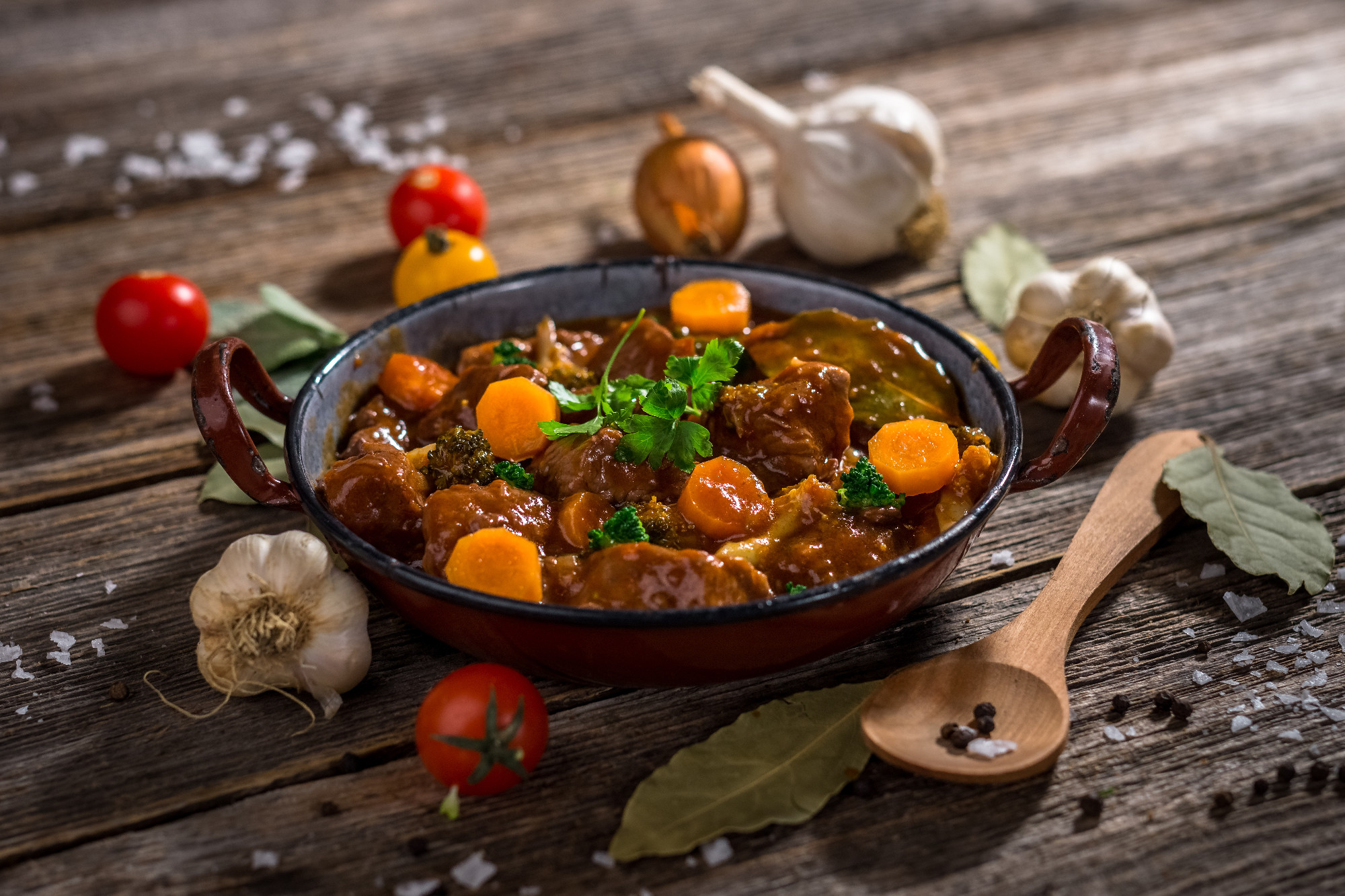 Meat stew with vegetable on rustic wooden background