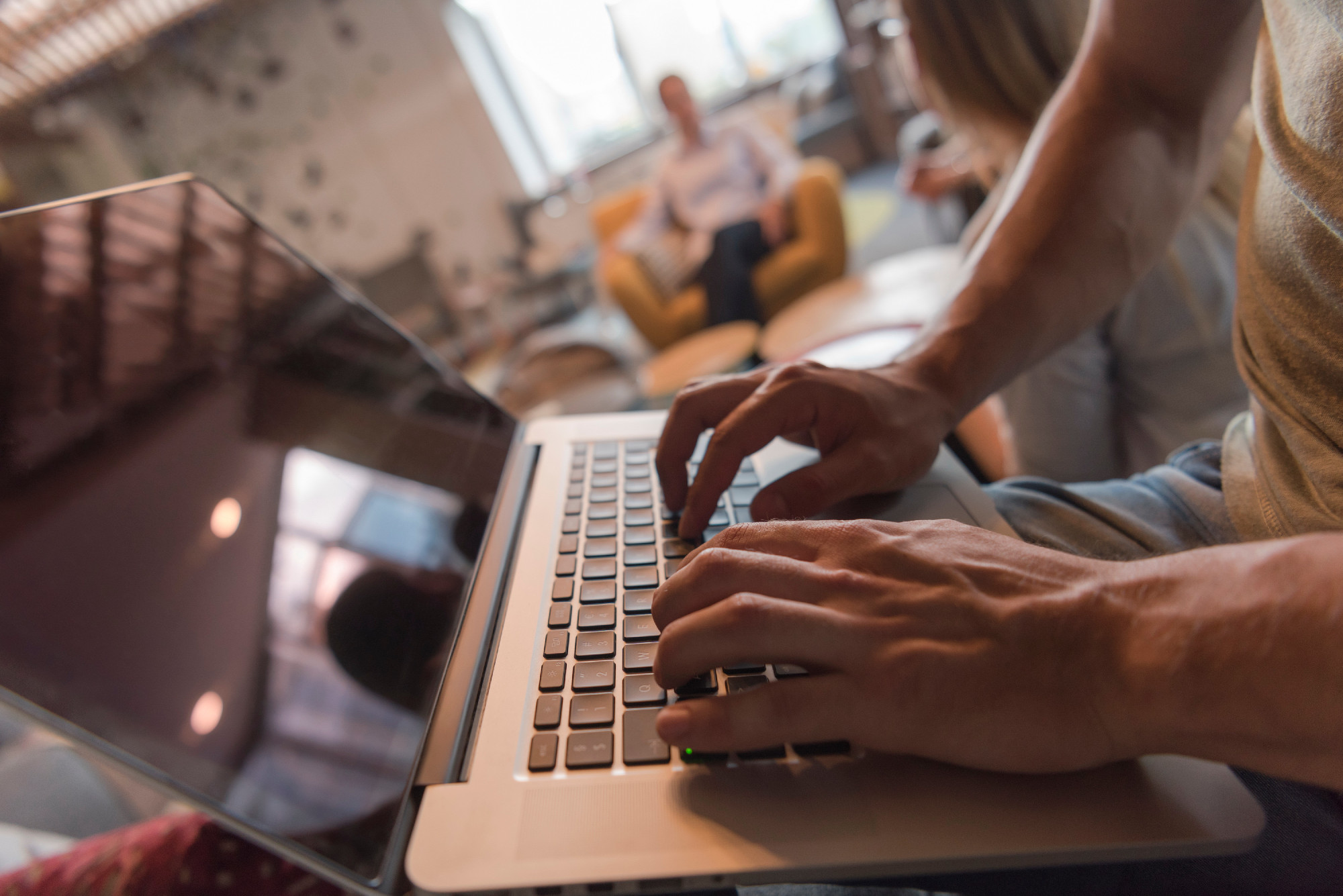 close up of male hands while working on laptop