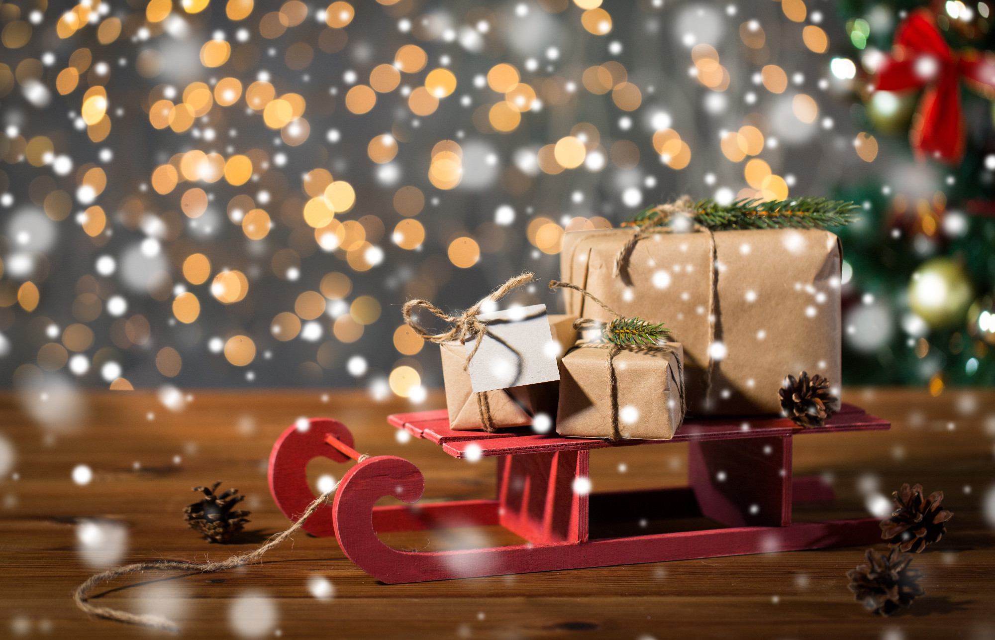 close up of christmas gift boxes on wooden sleigh