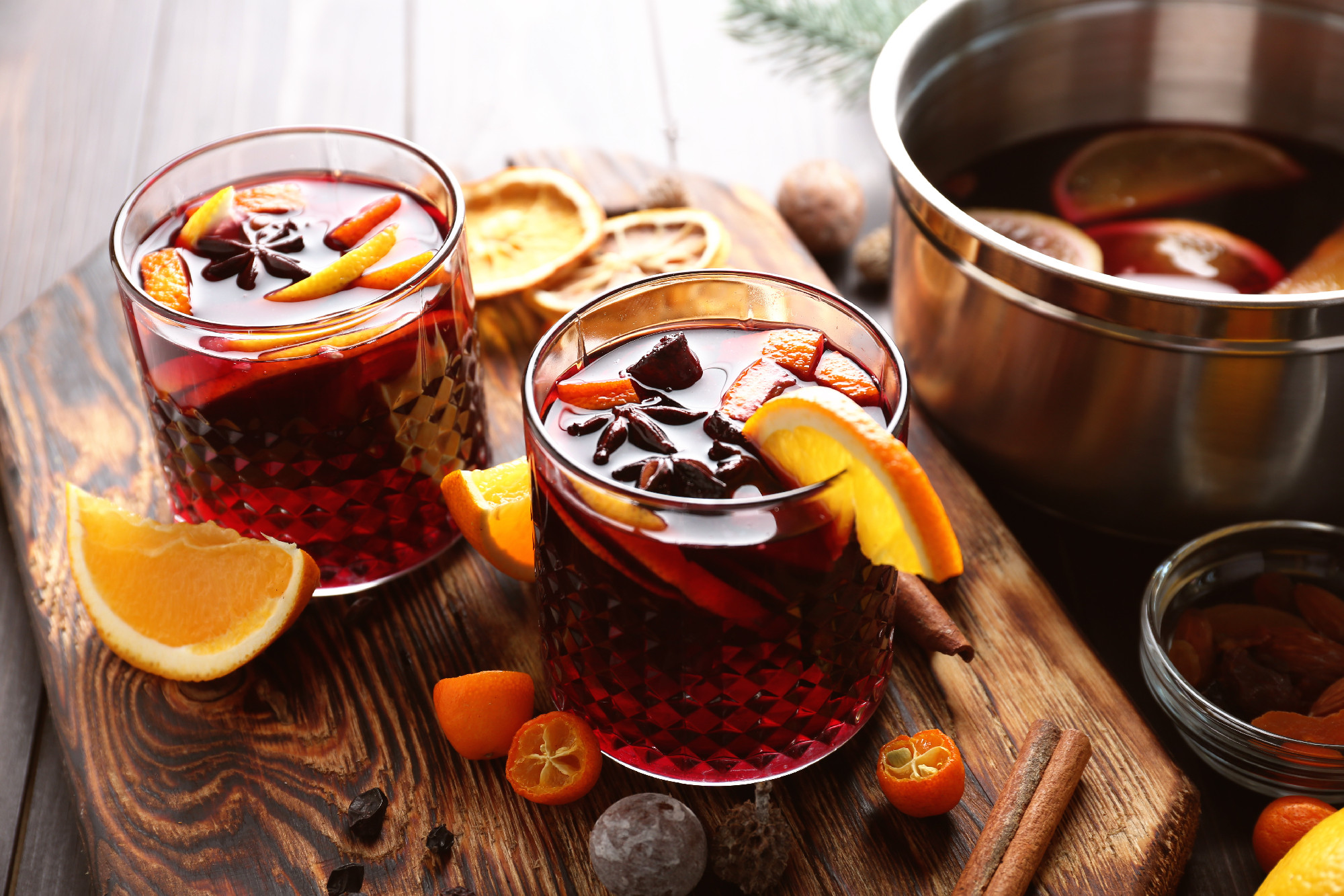 Glasses of delicious mulled wine on wooden board�