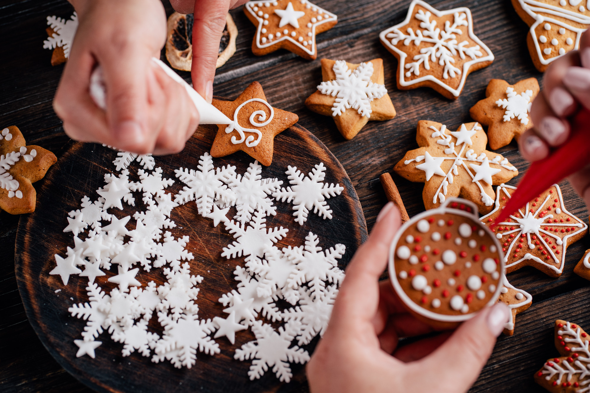 Friends decorating christmas gingerbread cookies