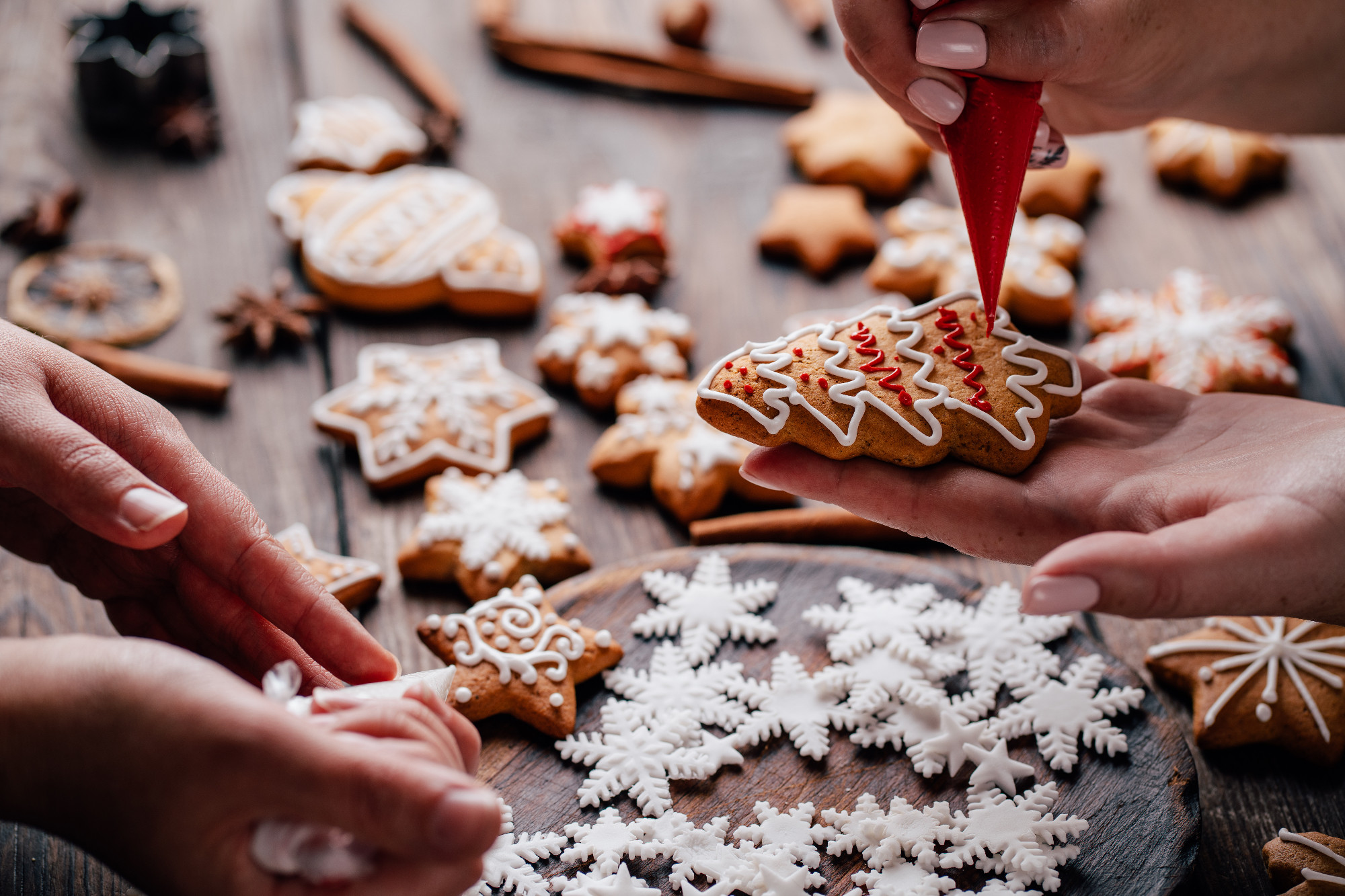 Friends decorating christmas gingerbread cookies