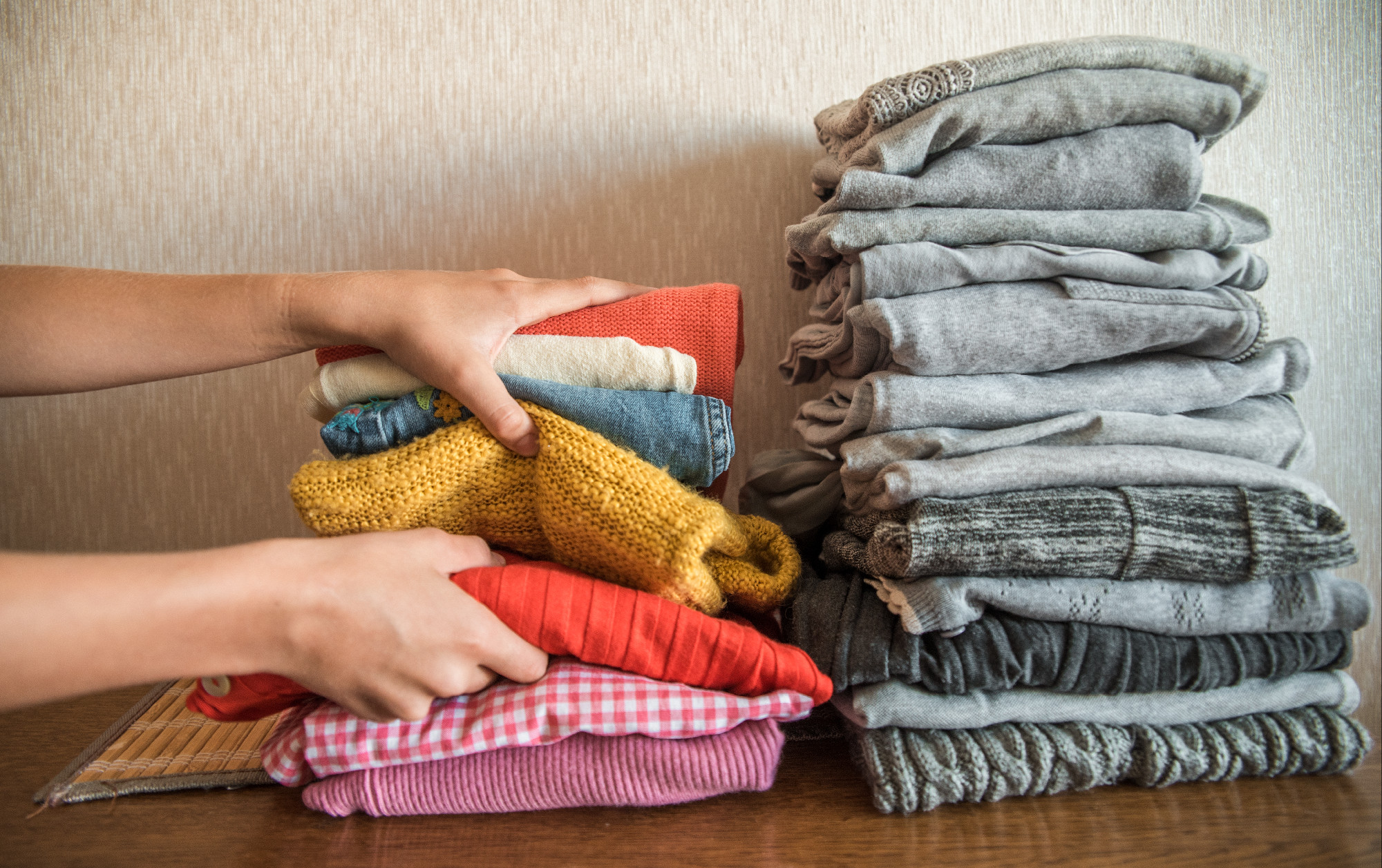 Red orange and yellow bright stack of clothes against the gray. The concept of choice and individuality