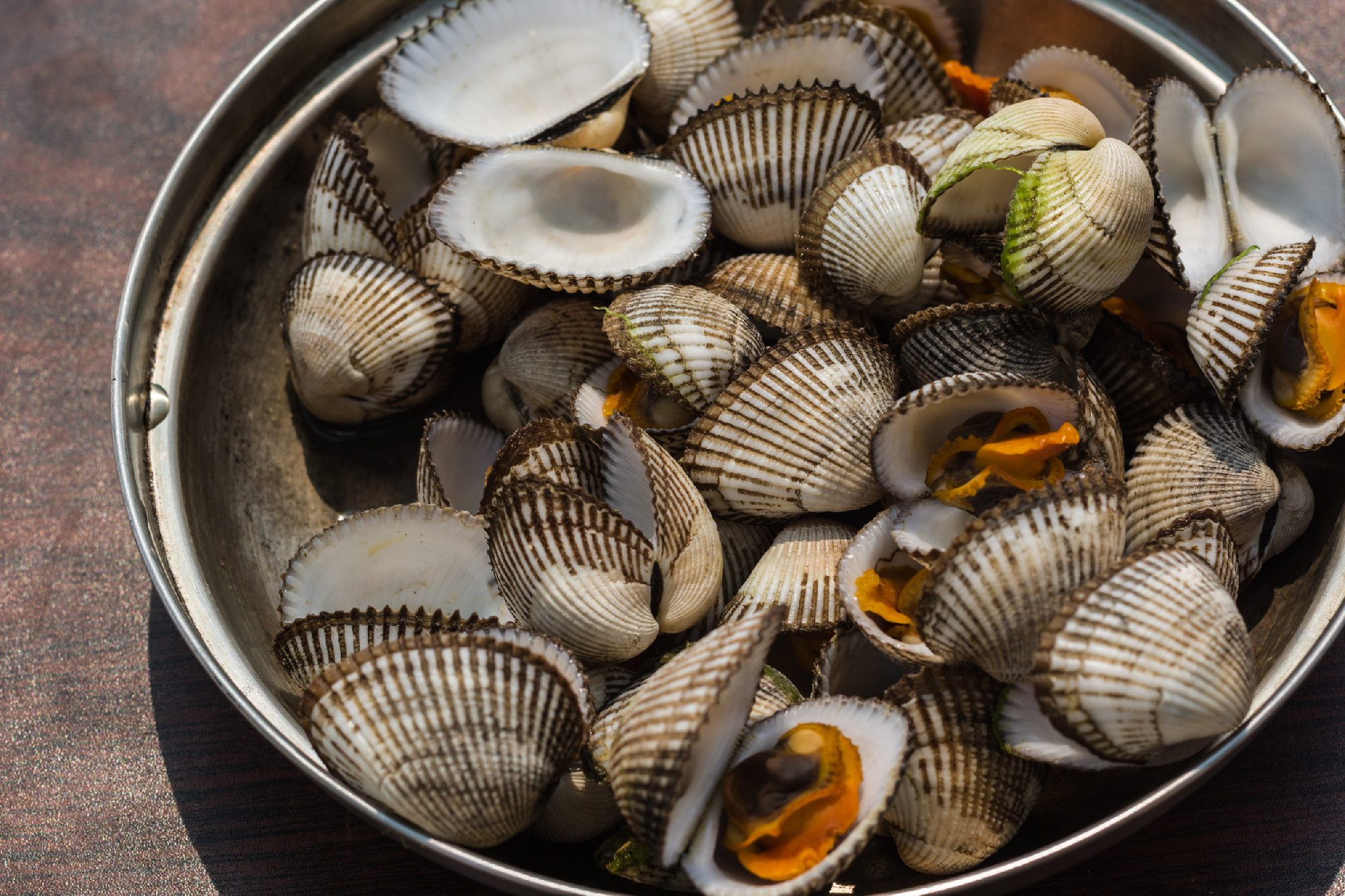 Sea shellfish cooked at a campfire on the beach