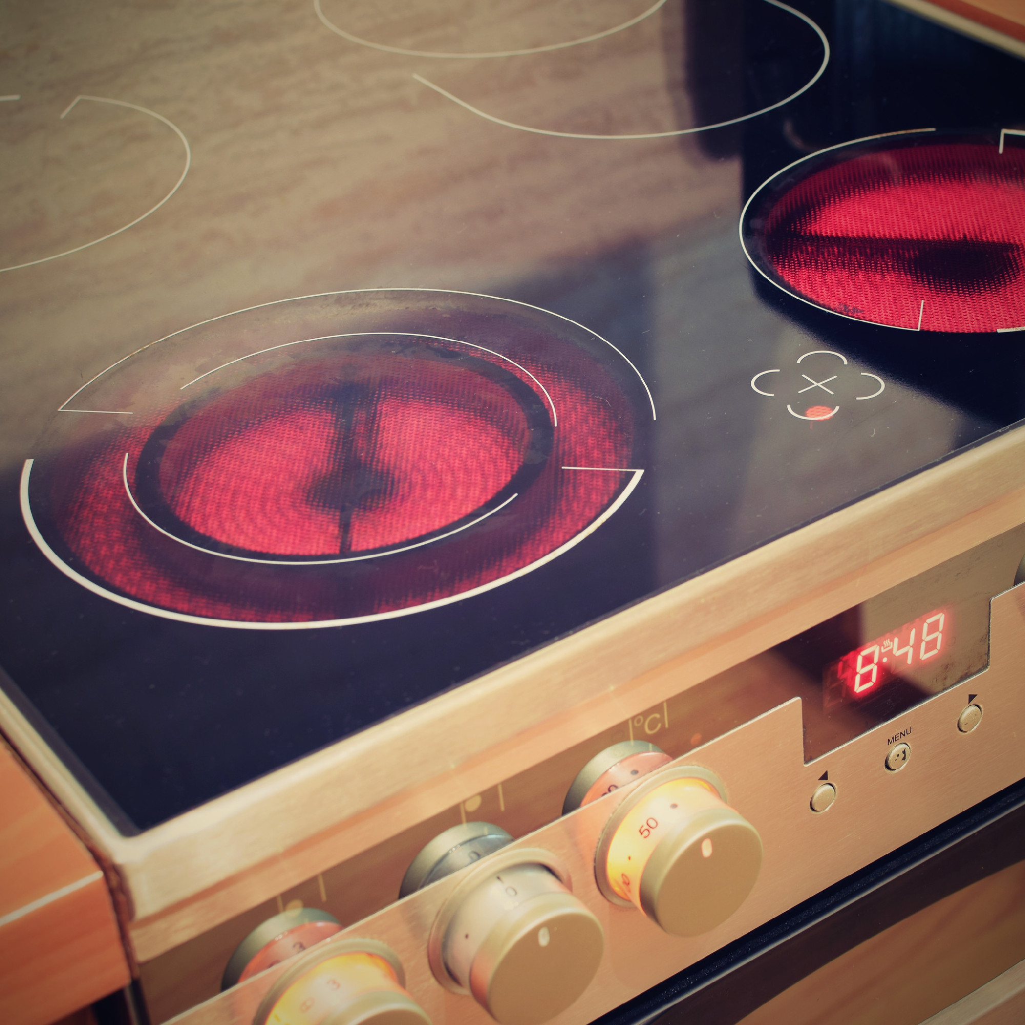 Electric ceramic stove inside the kitchen. Home interiors.