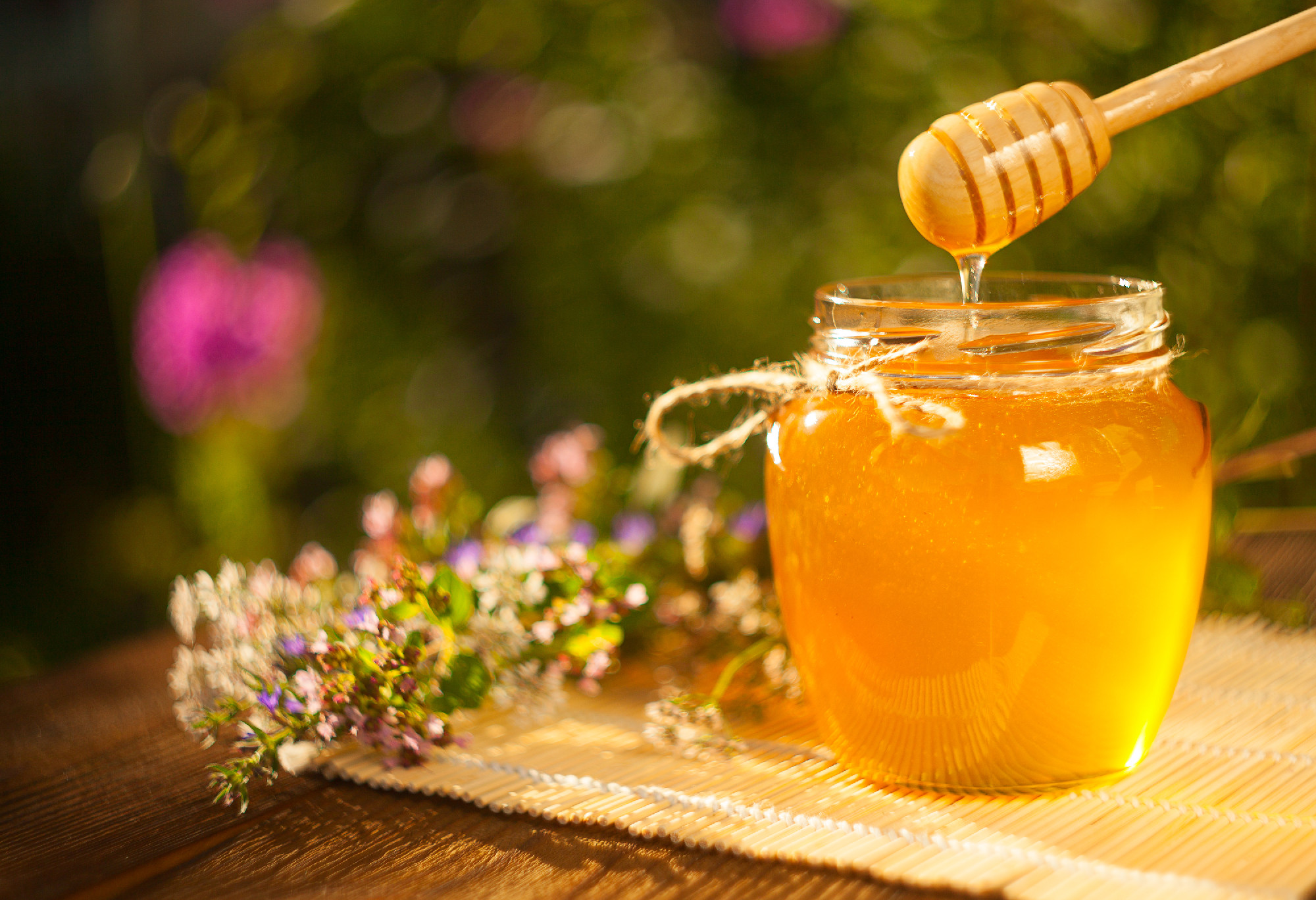 Delicious delicious honey in jar on table
