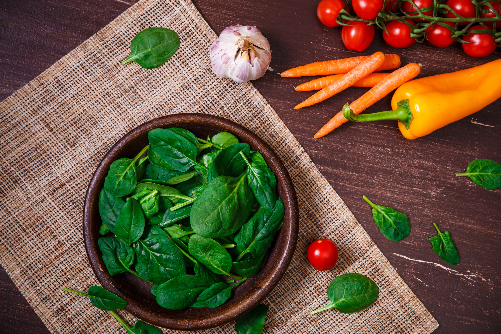 Spinach leaves in bowl. Raw fresh vegetable.