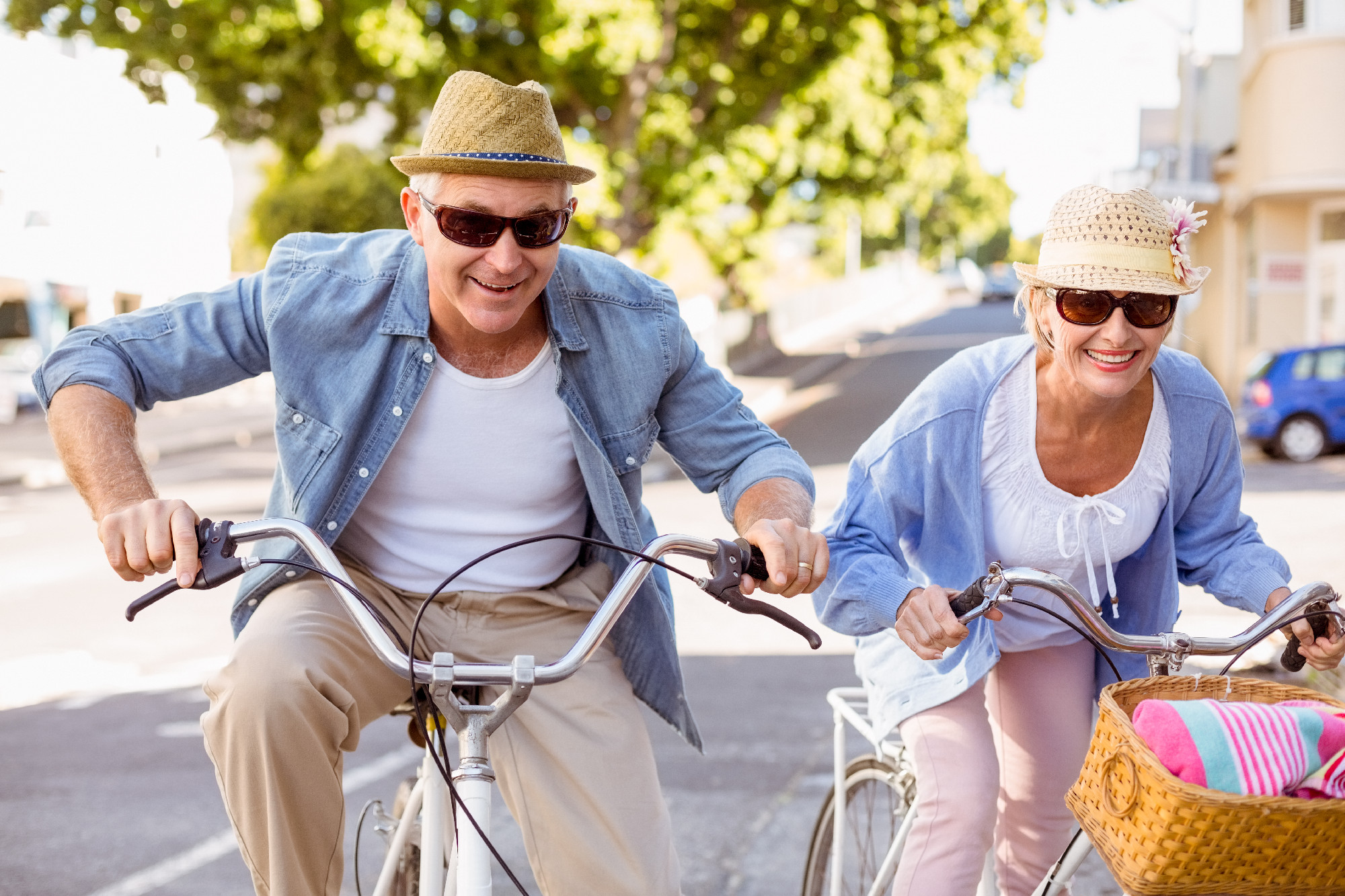 Happy mature couple going for a bike ride in the city