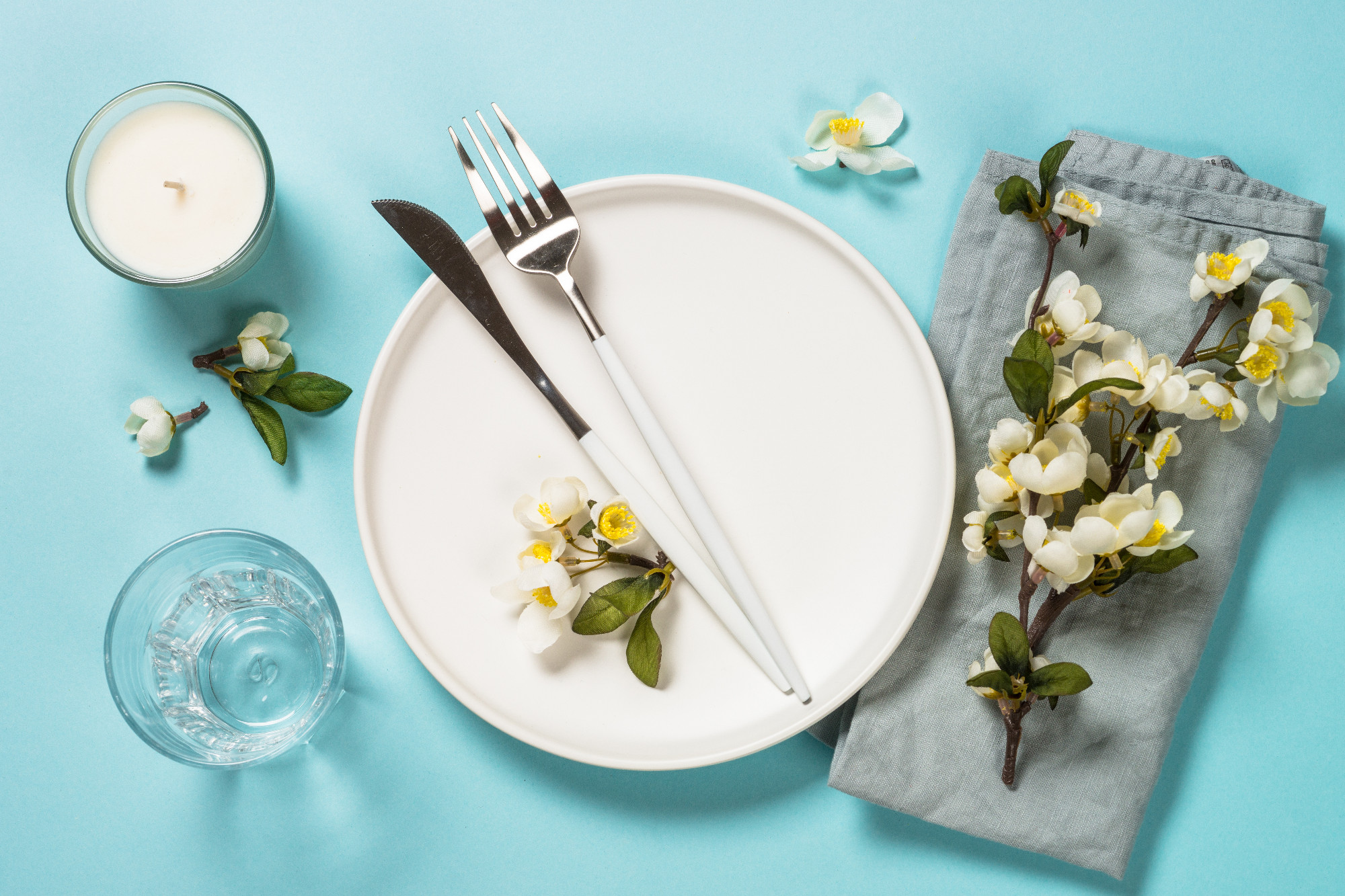 Spring table setting with flower top view.