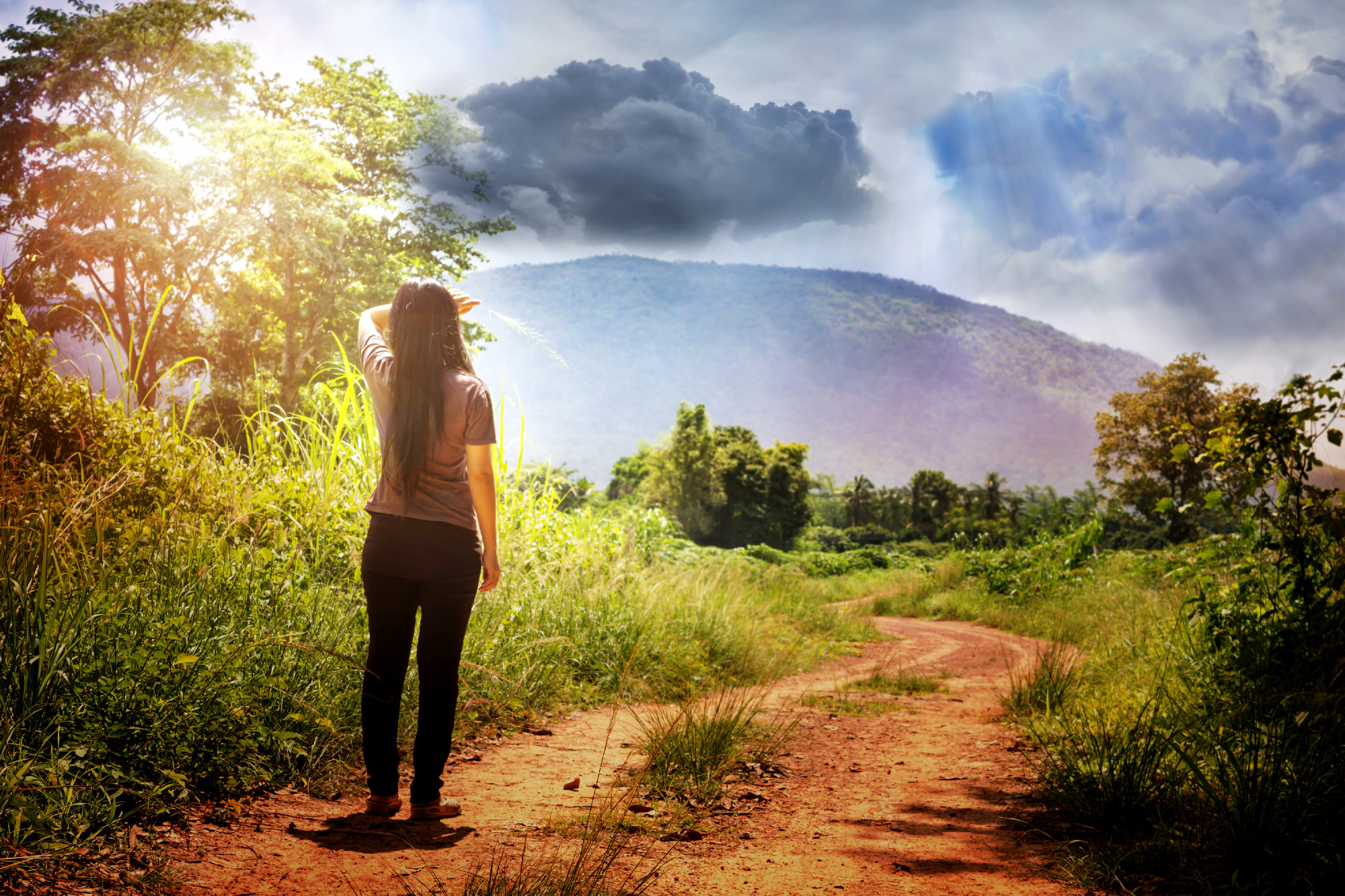 Back or rare view of girl or women and wierd clouds sky
