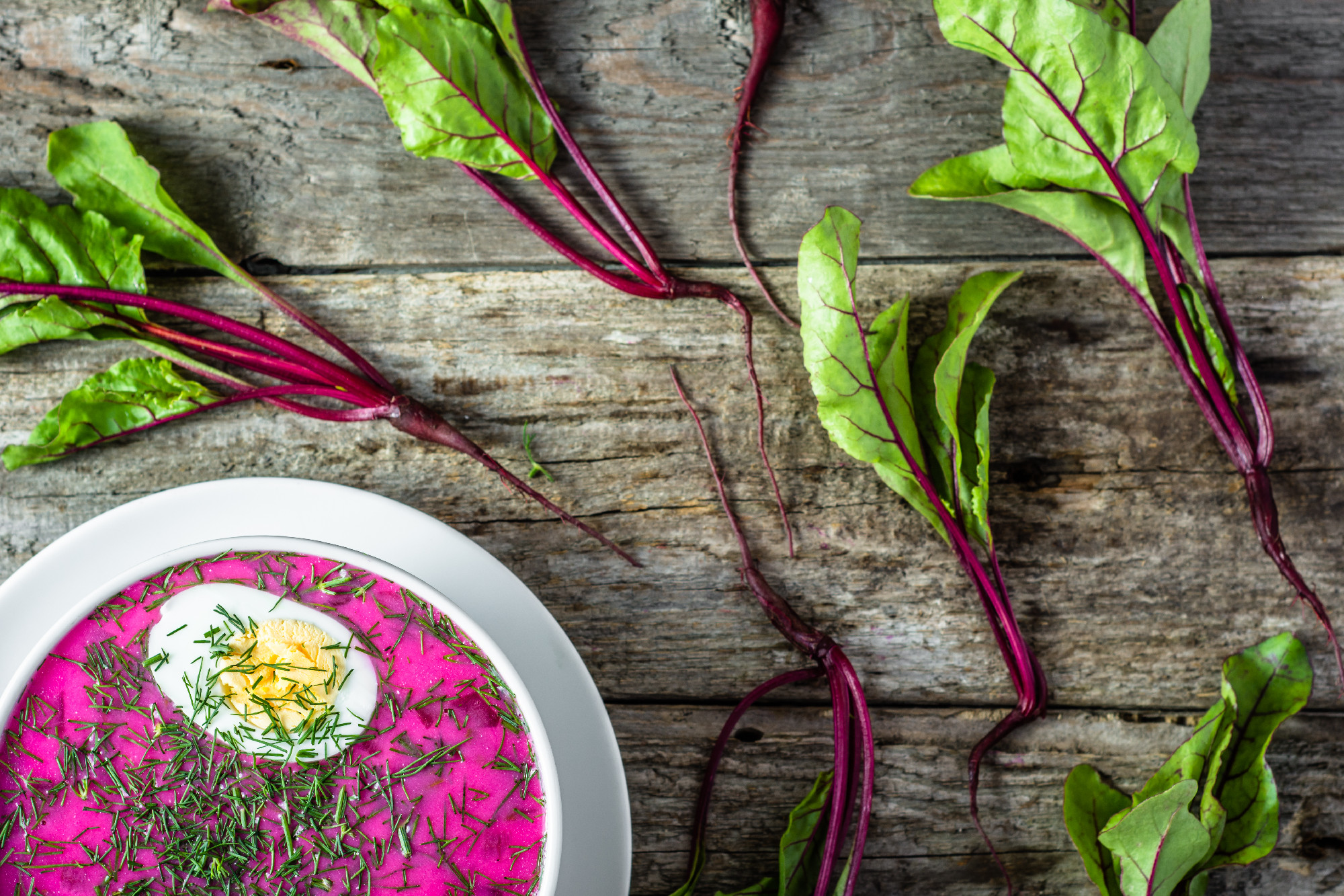 Cold soup with beet leaves served with cream, summer cooking con