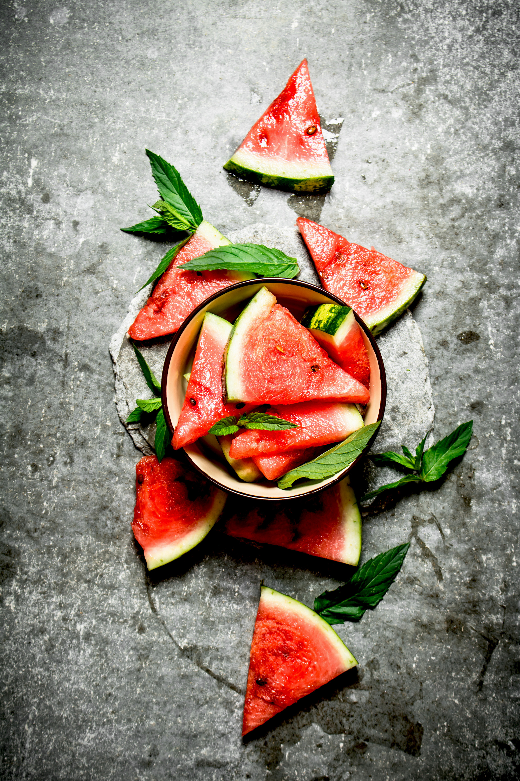 Pieces of watermelon in a bowl with mint.