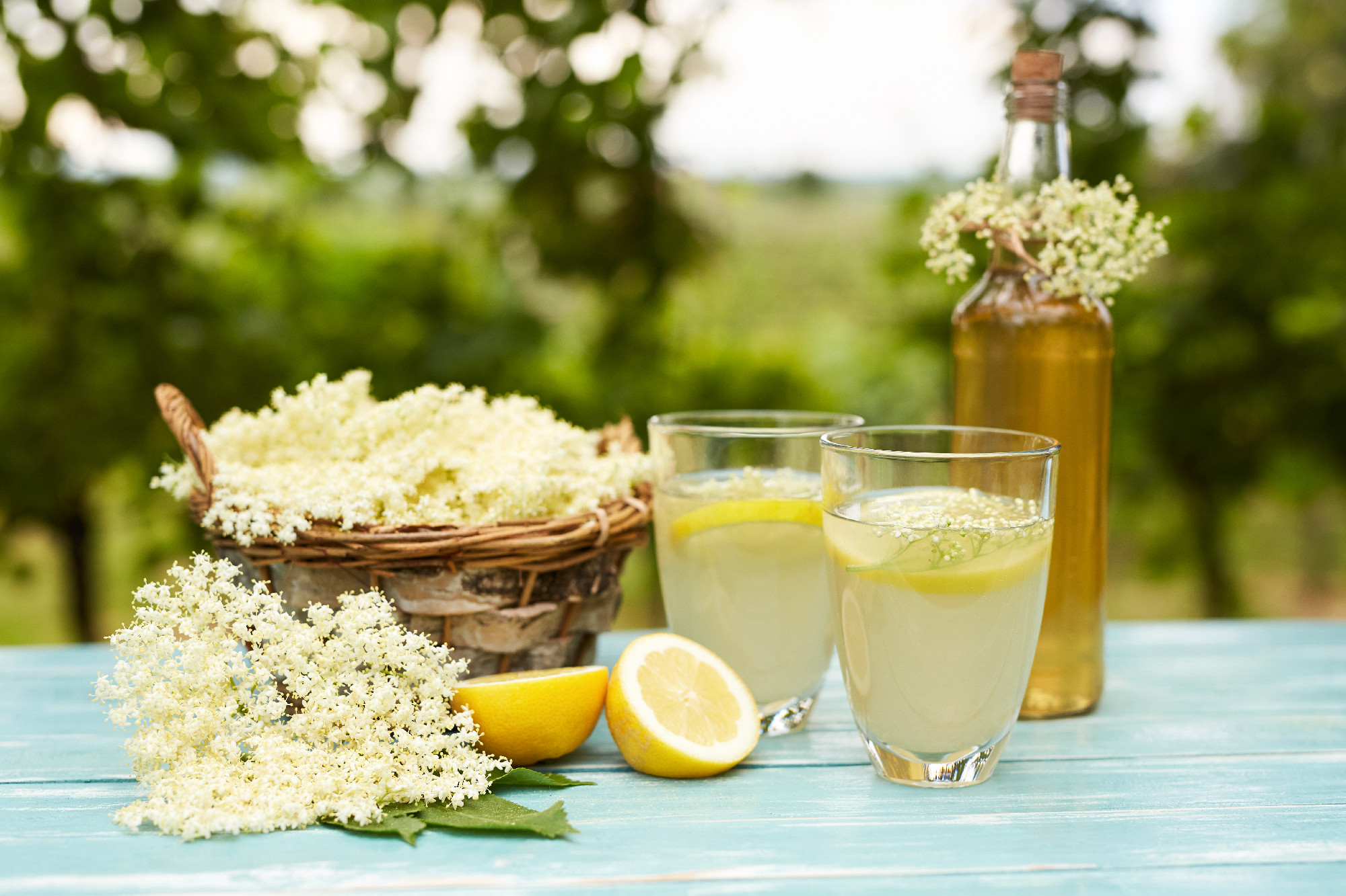 Two glasses of elderflower lemonade and bottle