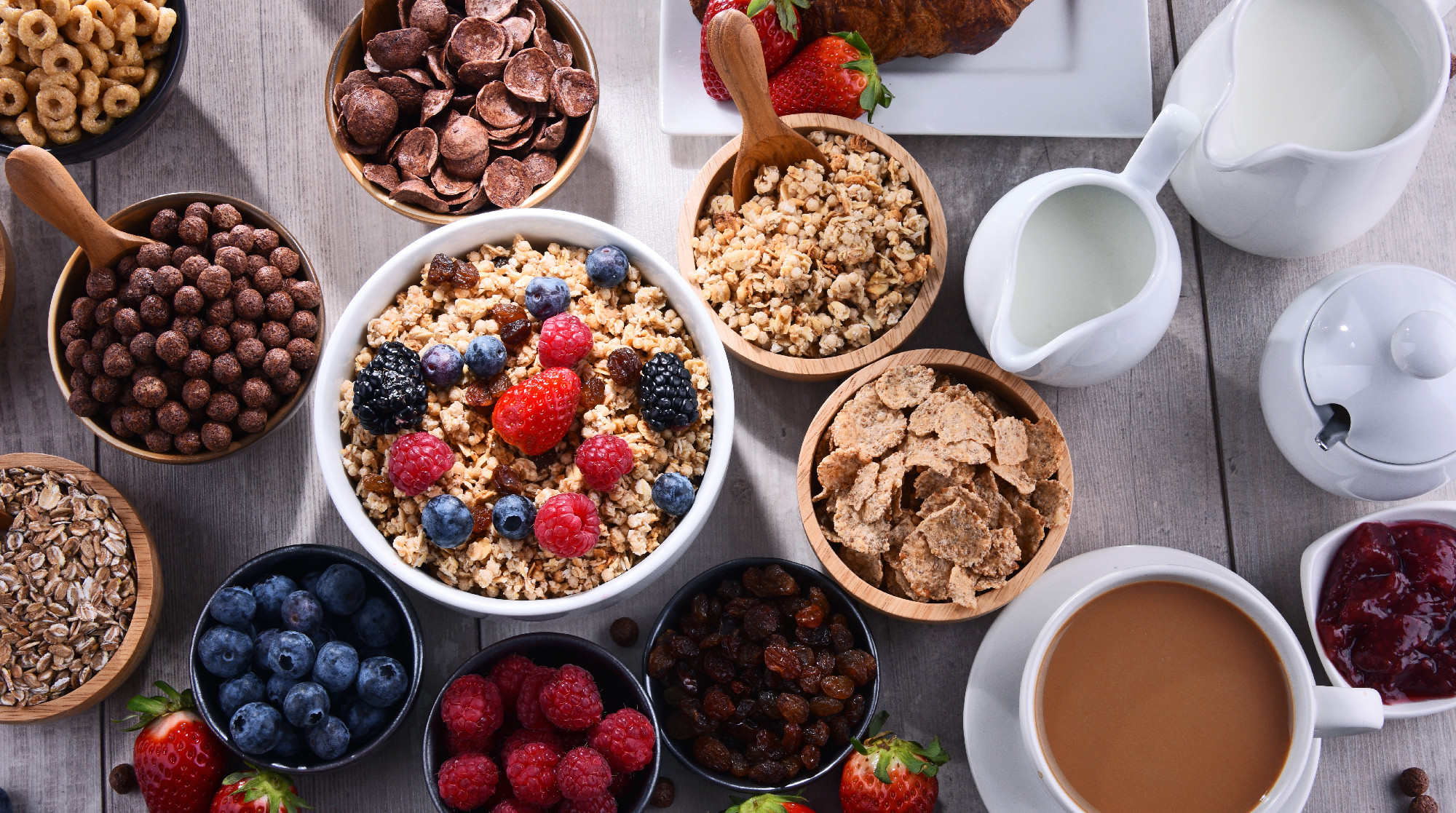 Different sorts of breakfast cereal products and fresh fruits