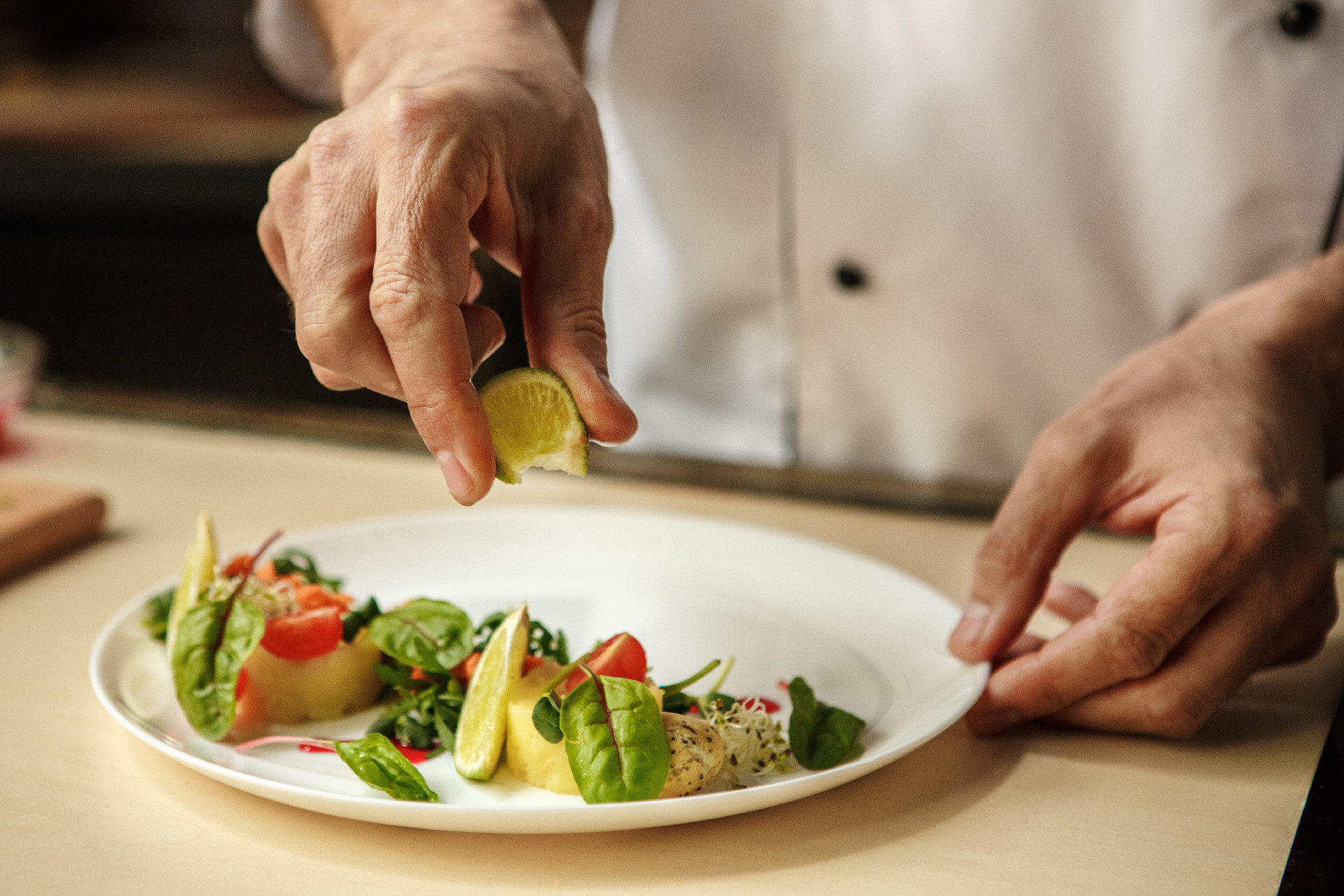 Mature man professional chef cooking meal indoors