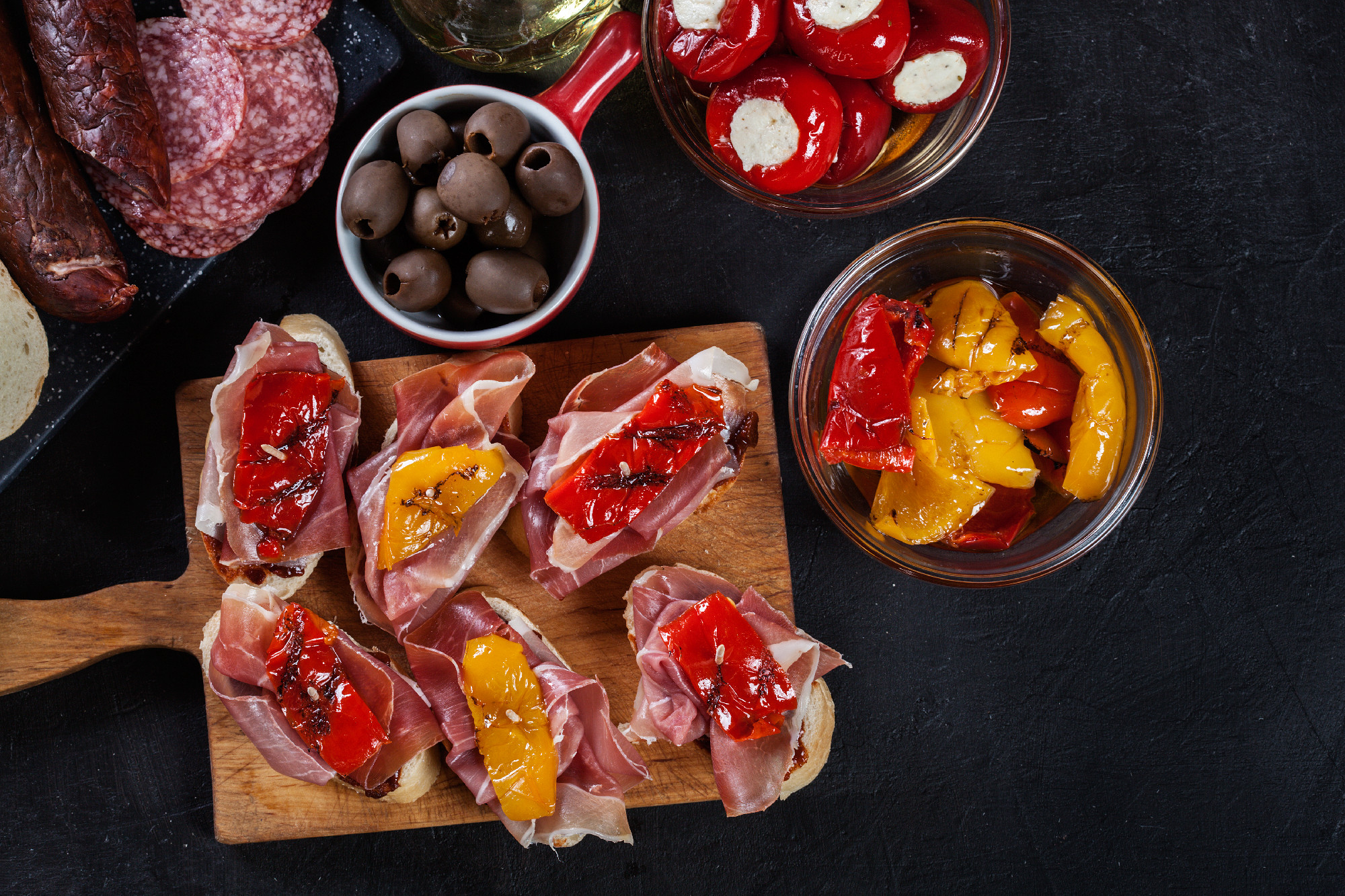 Spanish tapas with slices jamon serrano and grilled pepper. Also