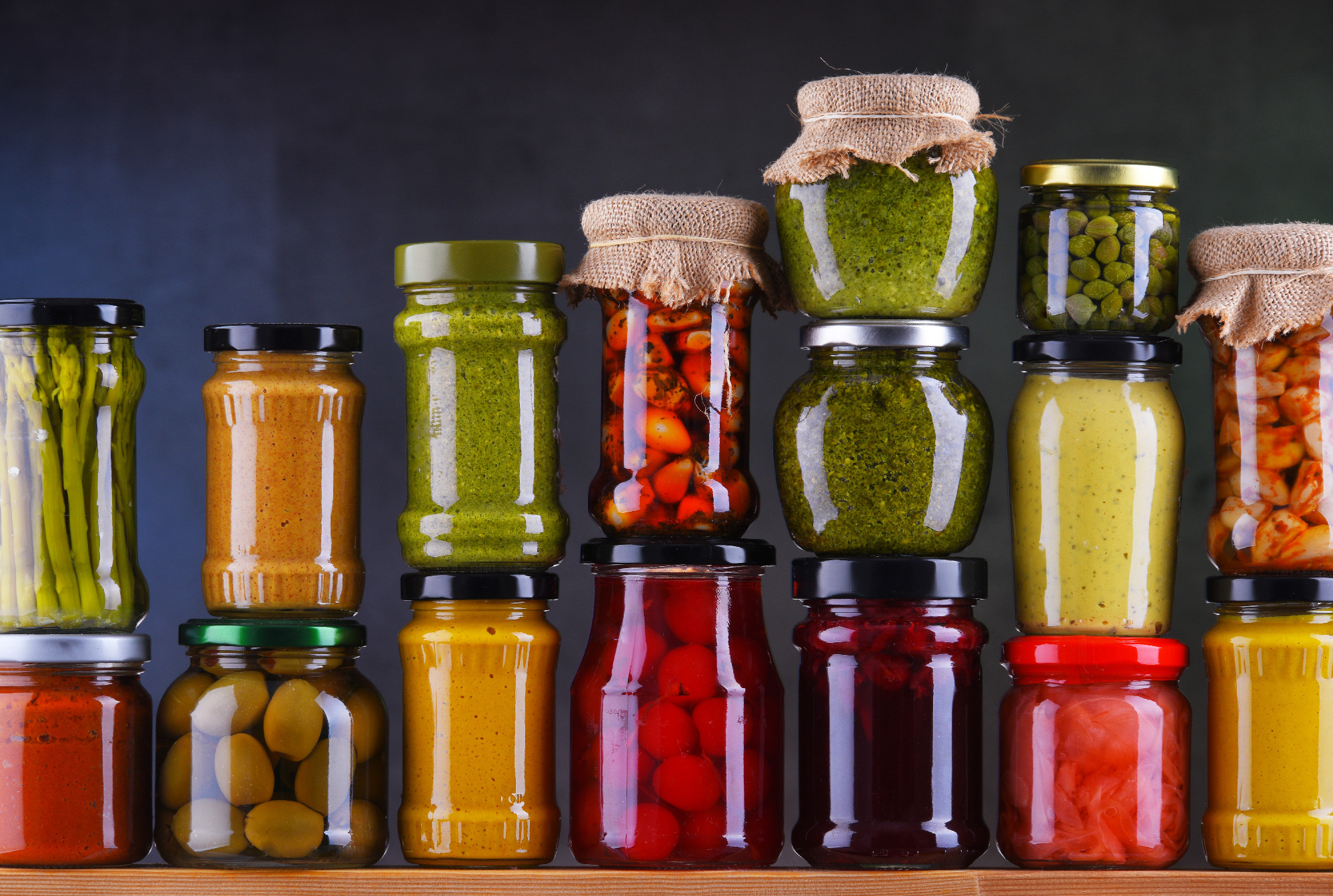 Jars with variety of pickled vegetables and fruits