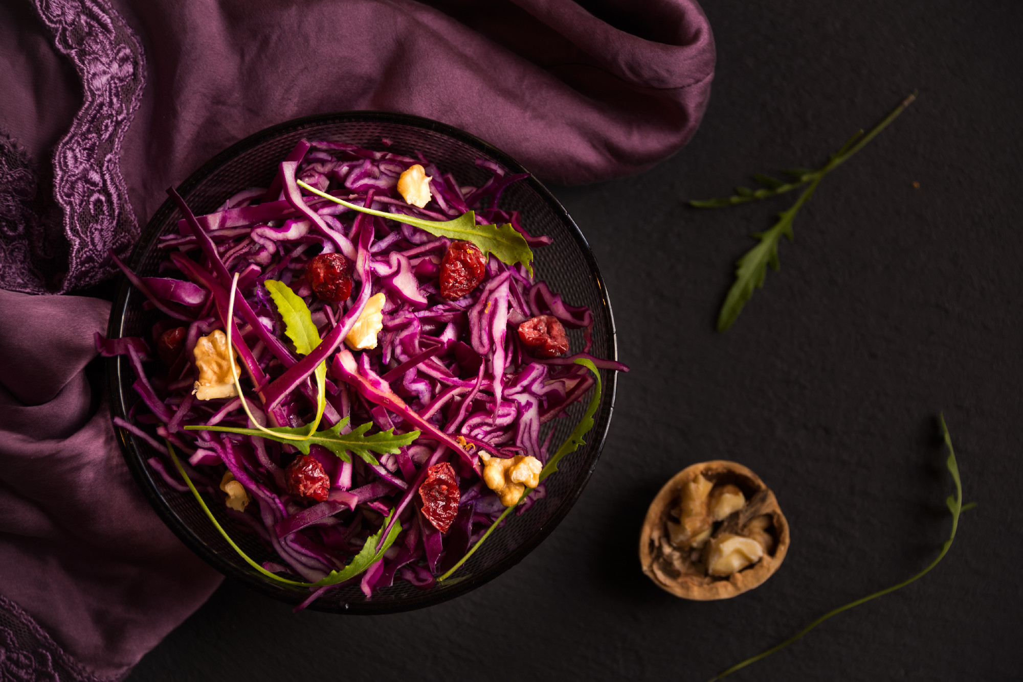 Red cabbage salad with nuts and arugola
