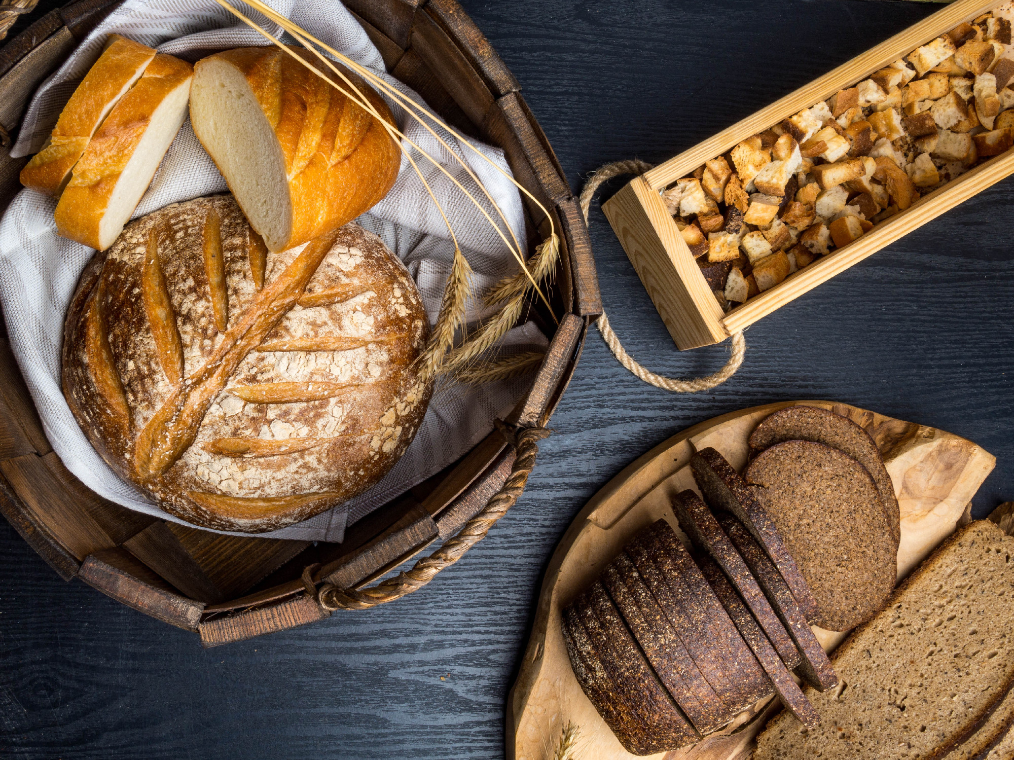 assortment of baked bread on wooden background