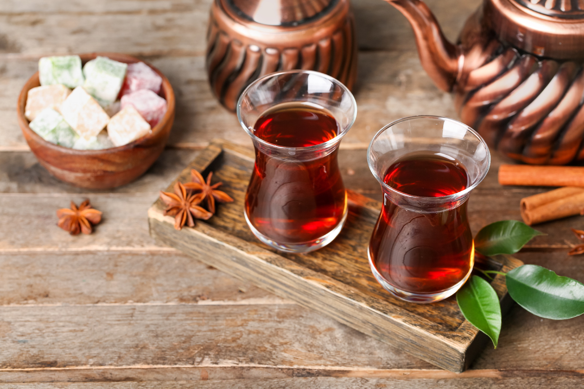 Board with cups of Turkish tea on wooden background�