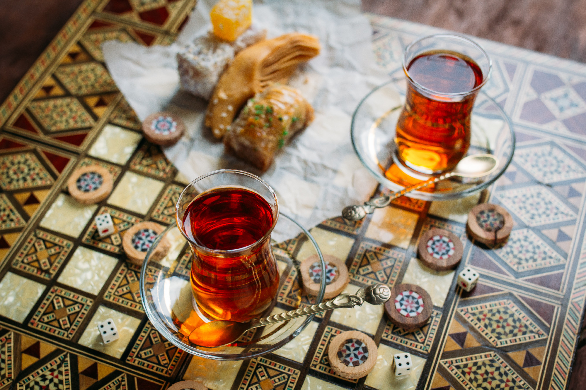 Turkish sweets and tea on the backgammon Board