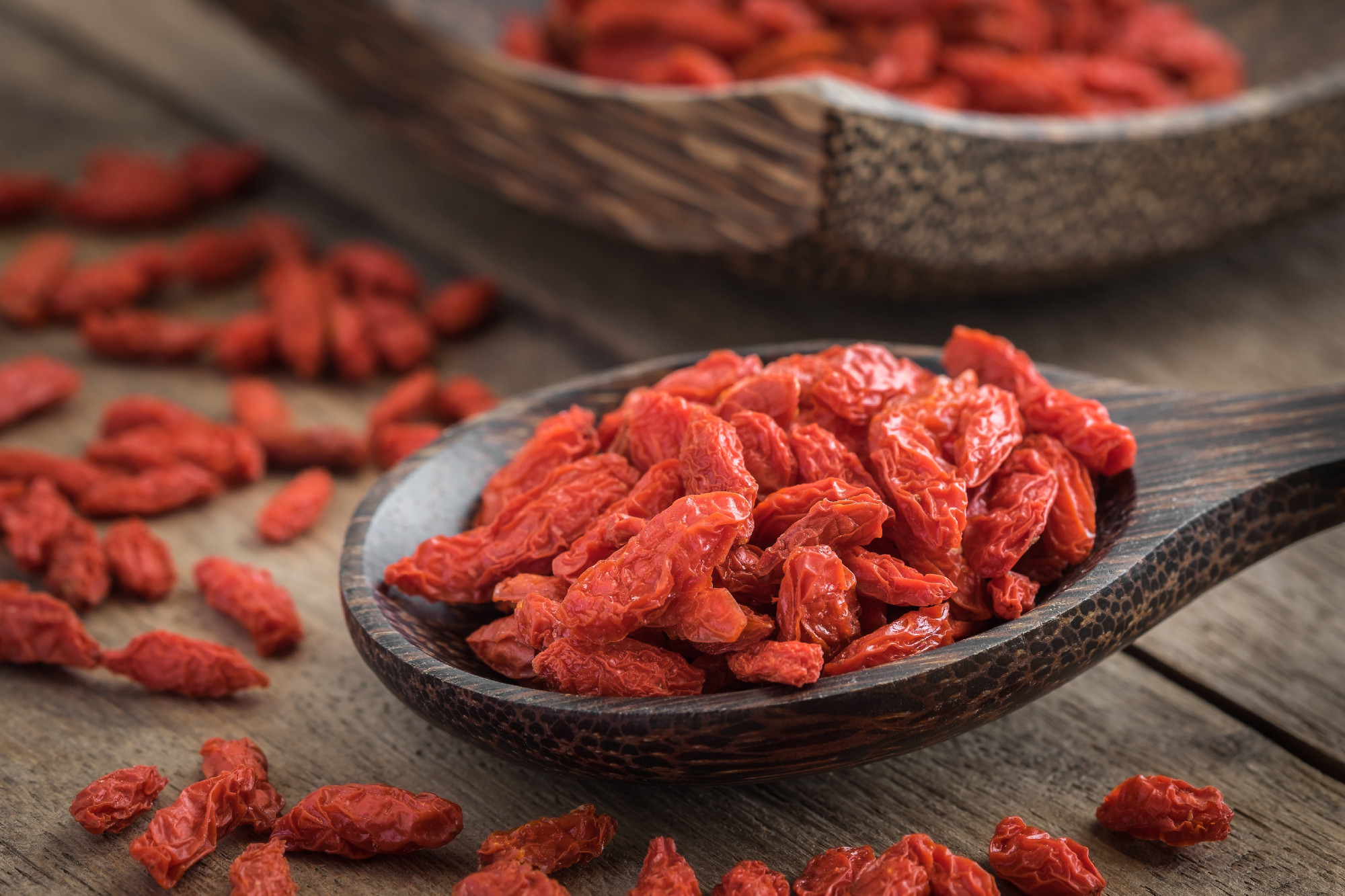 Goji berries on wooden spoon