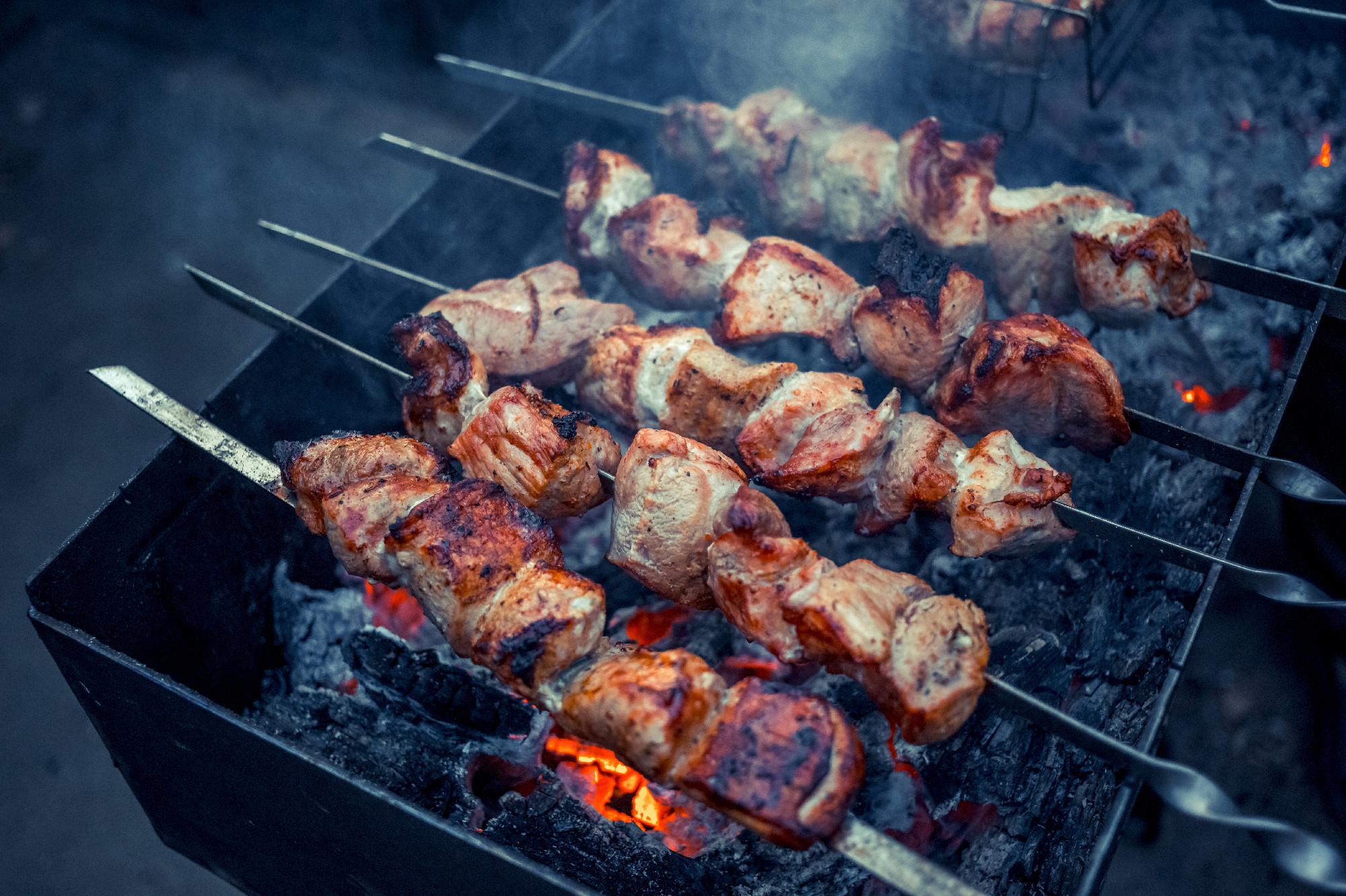 Grilled kebab cooking on metal skewers (grill). Roasted meat coo