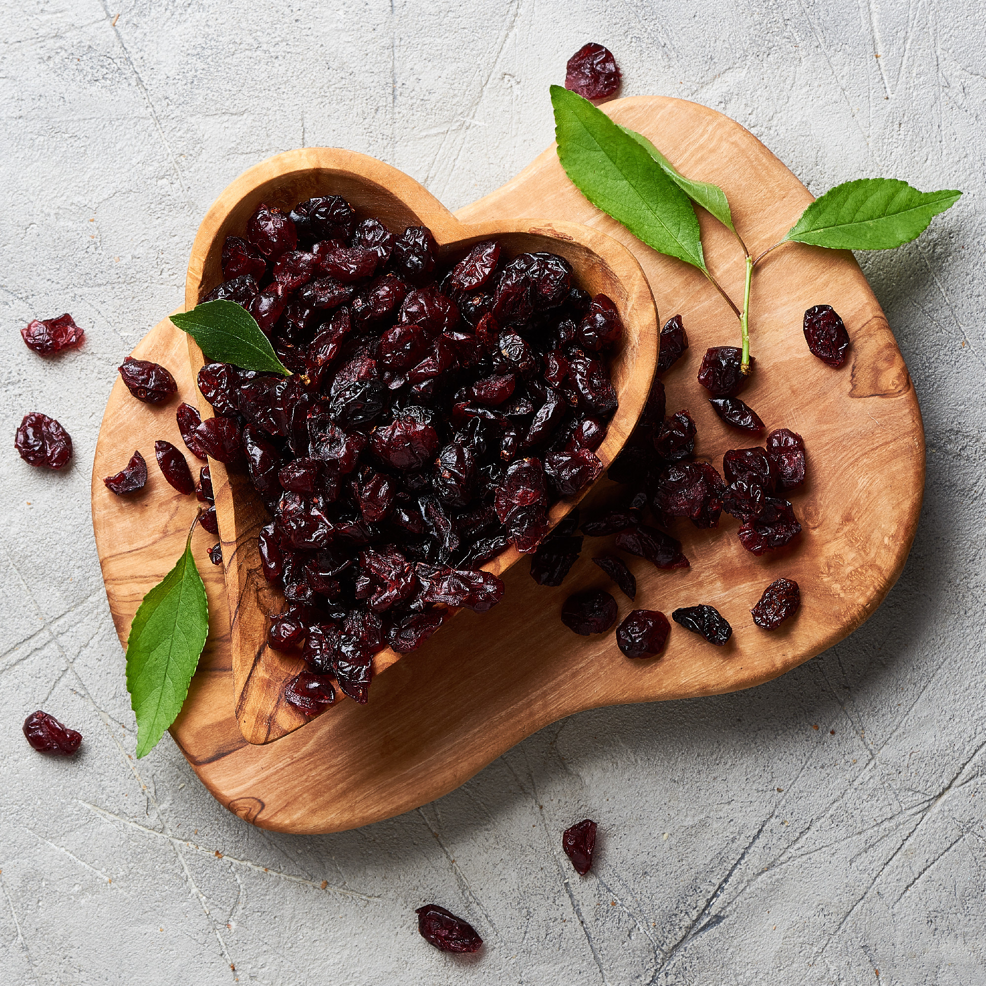Dried cherry in a bowl over gray background. Top view.