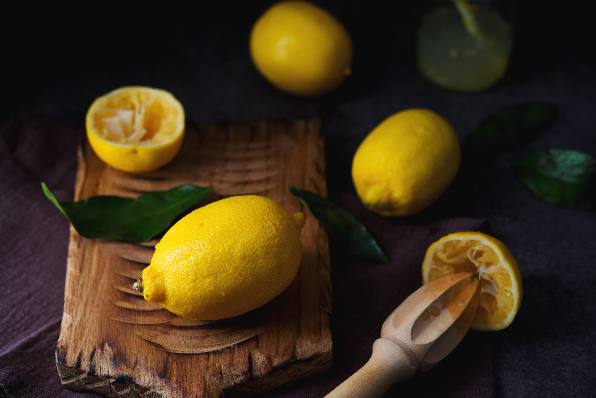 Ripe juicy organic lemons on a wooden board