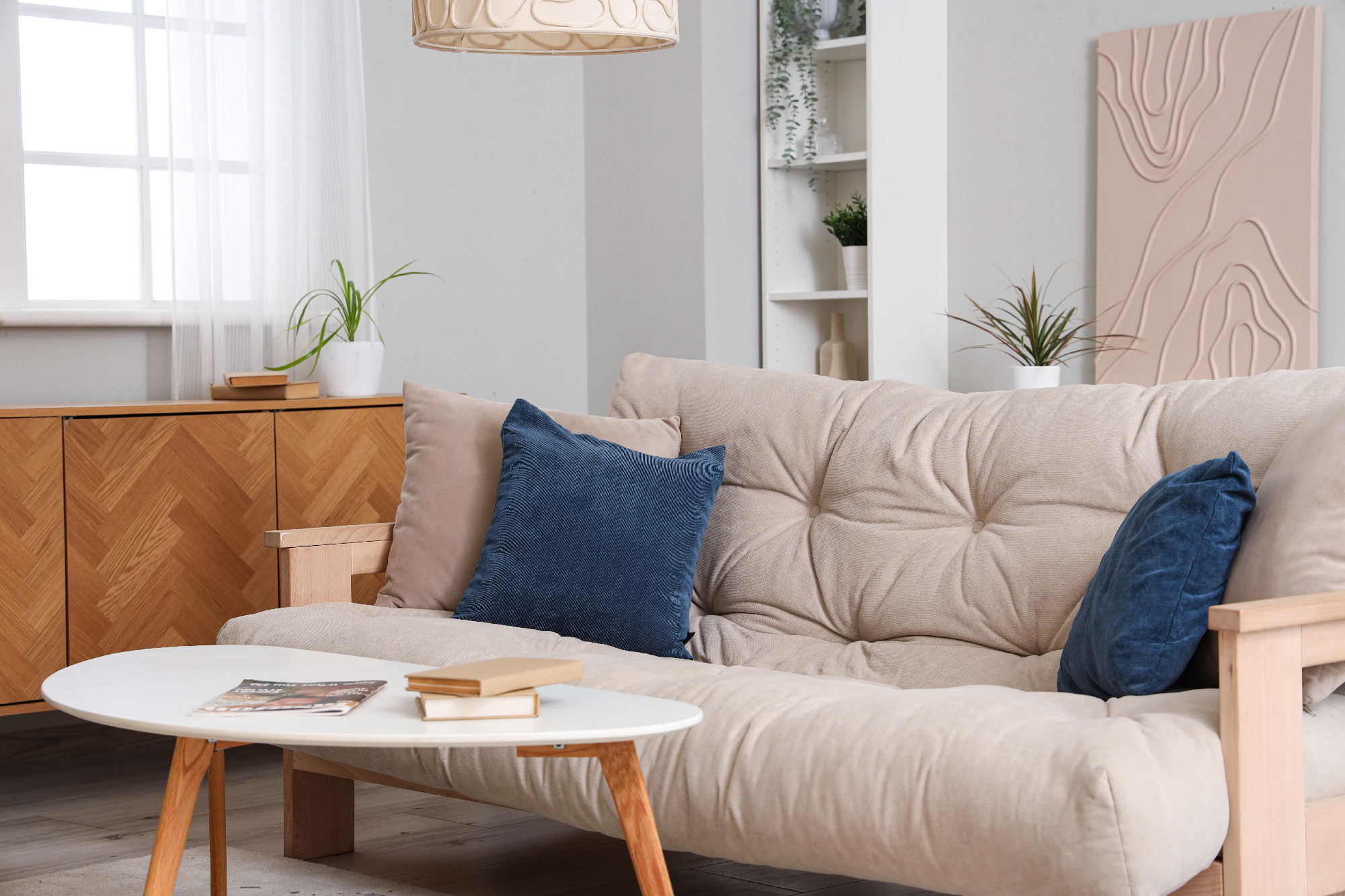 Stylish interior of living room with soft sofa and coffee table�